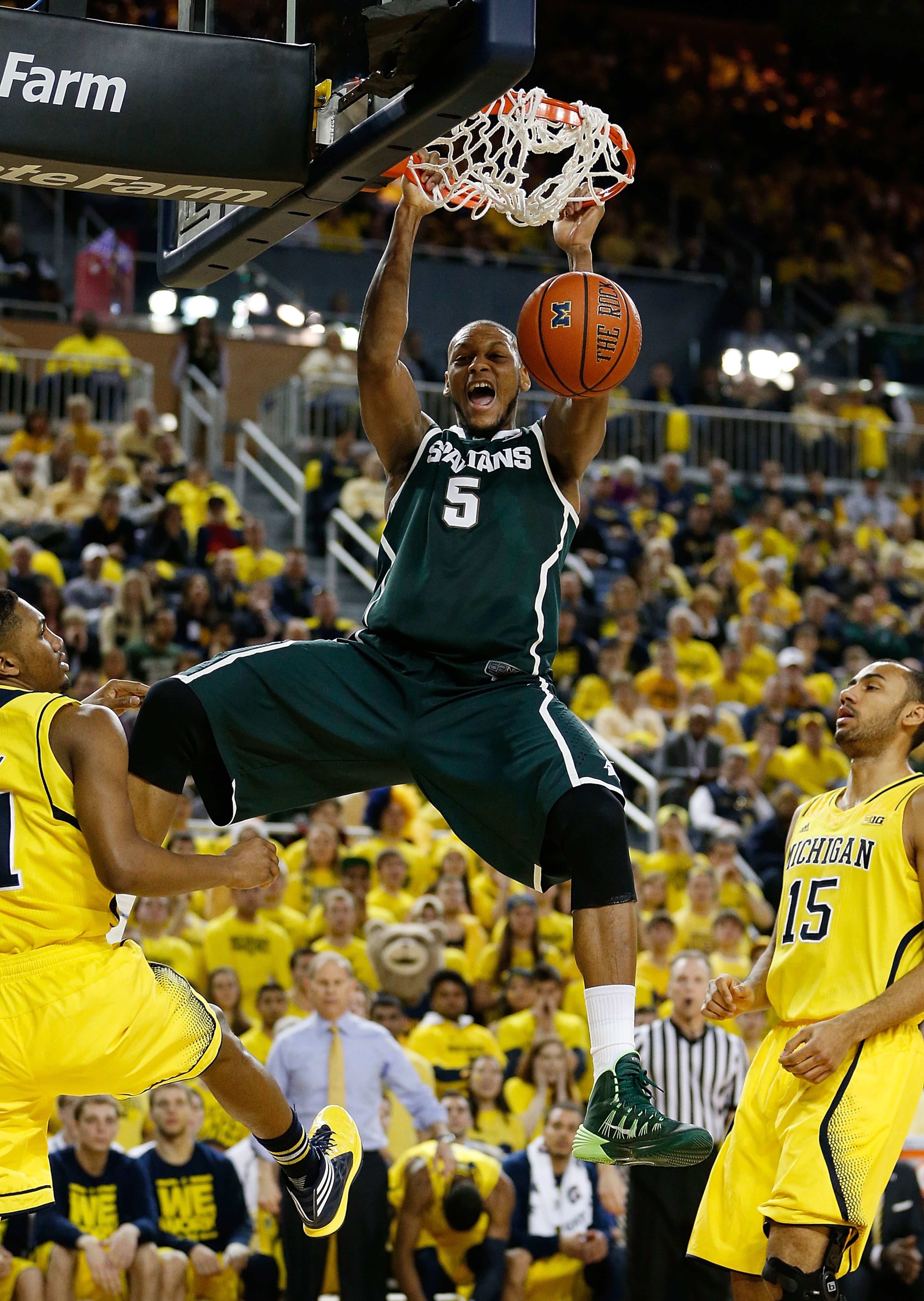 Adreian Payne #5 of the Michigan State Spartans gets in for a first half dunk next to Zak Irvin #21 and Jon Horford #15 of the Michigan Wolverines at Crisler Center on February 23, 2014 in Ann Arbor, Michigan. (Photo by Gregory Shamus/Getty Images)