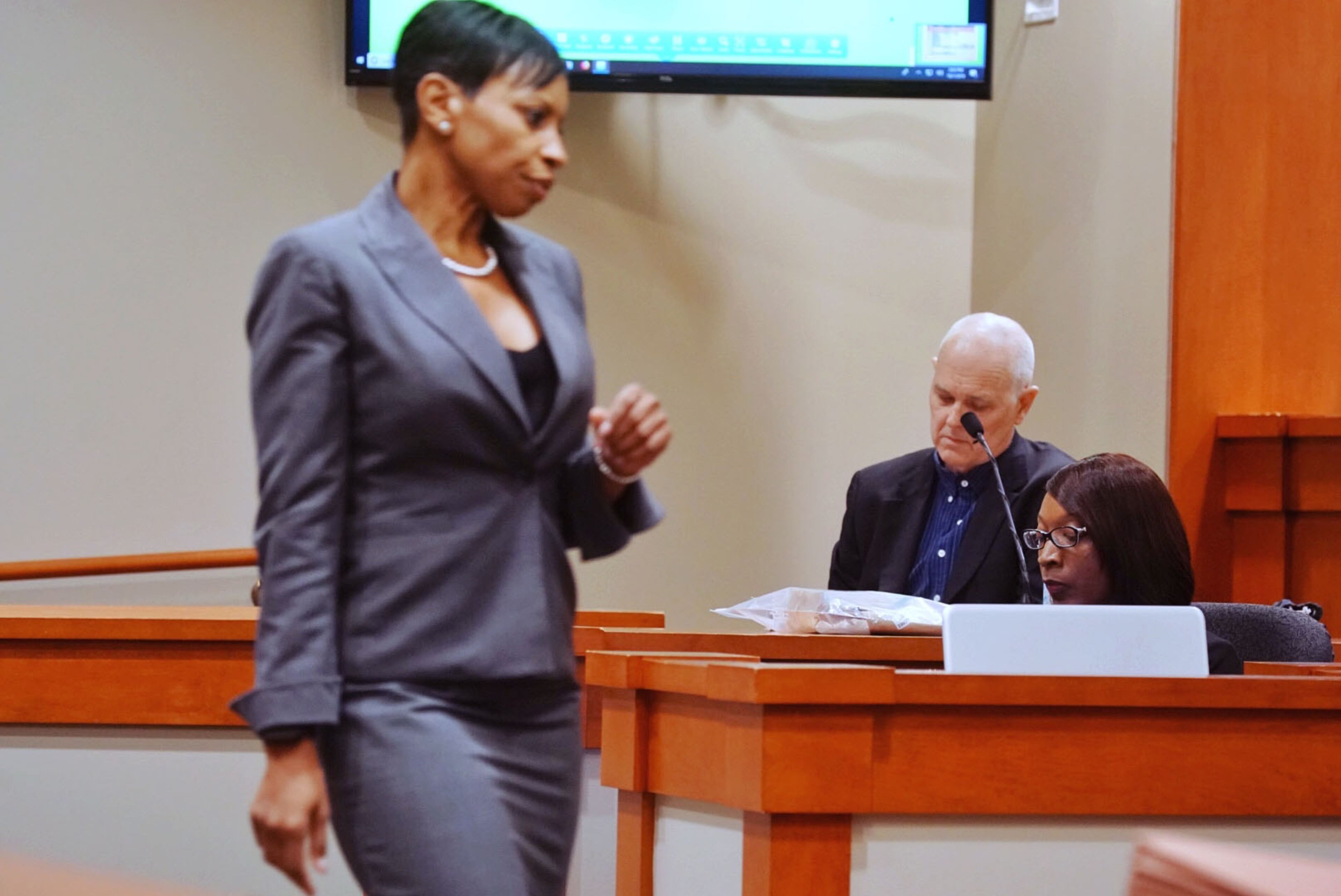 Dr. Geoffrey Smith, deputy chief medical examiner at the Dekalb County Medical Examiner's office, looks at his autopsy report as lead prosecutor Buffy Thomas walks away from the witness stand during day three of the Robert Olson murder trial at the DeKalb County Courthouse on October 1, 2019 in Decatur. Olsen is charged with murdering war veteran Anthony Hill. (Elijah Nouvelage for The Atlanta Journal Constitution)