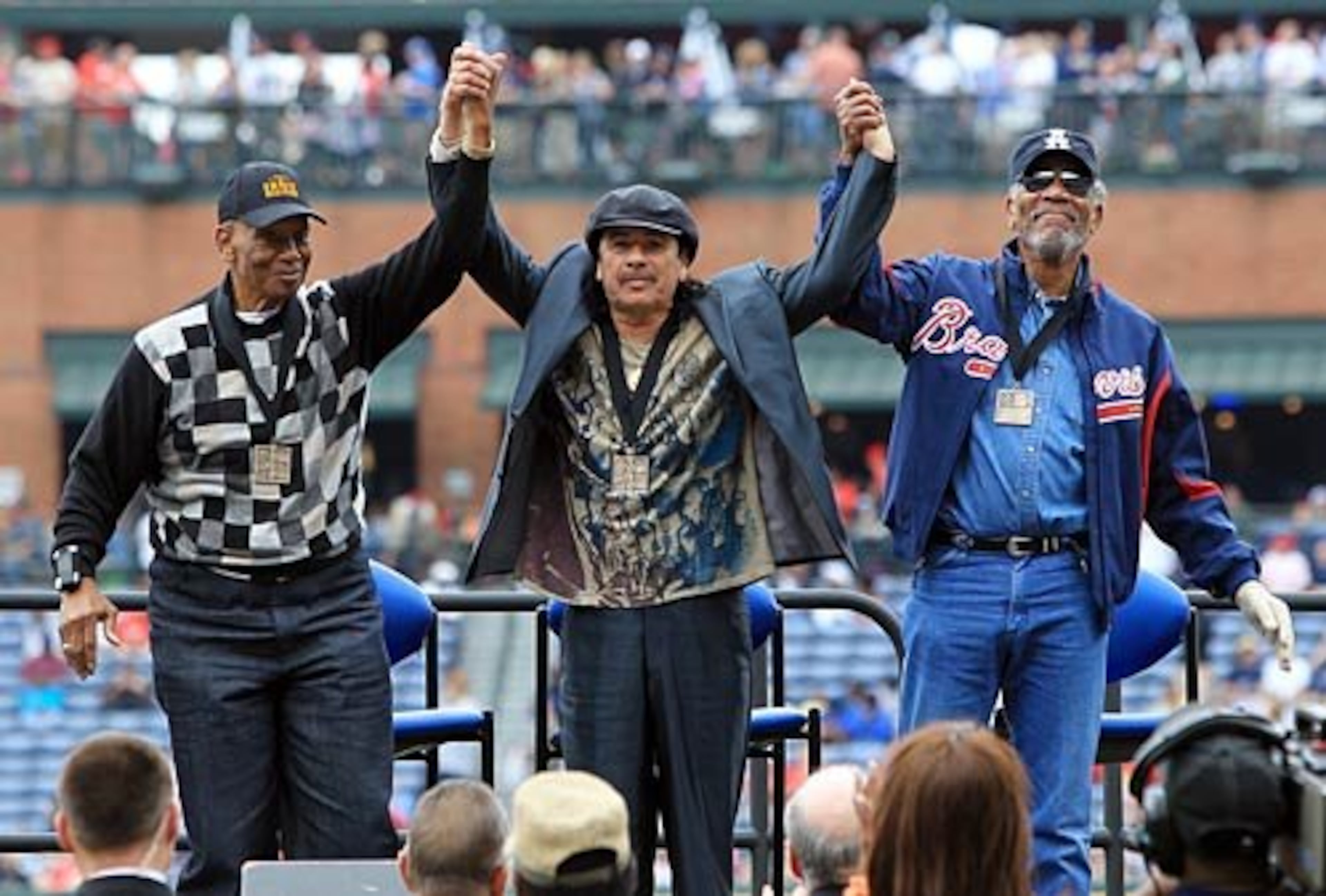 Hall of Fame shortstop Ernie Banks, musician Carlos Santana and actor Morgan Freeman are presented Beacon Awards by Major League Baseball during a pregame presentation on-field at the MLB Civil Rights Game at Turner Field in Atlanta on Sunday, May 15, 2011.