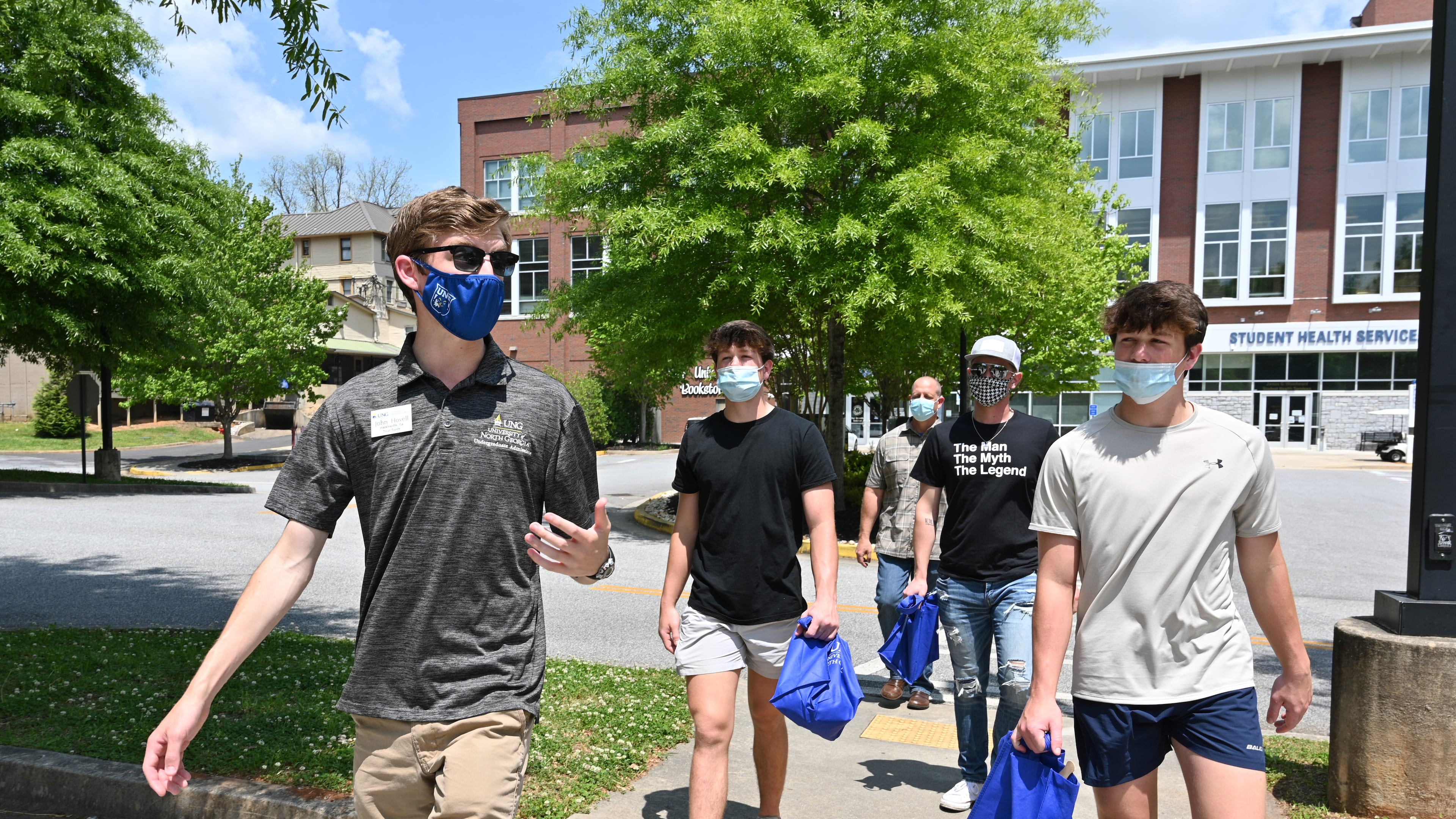 Tour guide John Hovell (left) leads potential students and a parent on a tour of the University of North Georgia's Dahlonega Campus on Wednesday. (Hyosub Shin / Hyosub.Shin@ajc.com)
