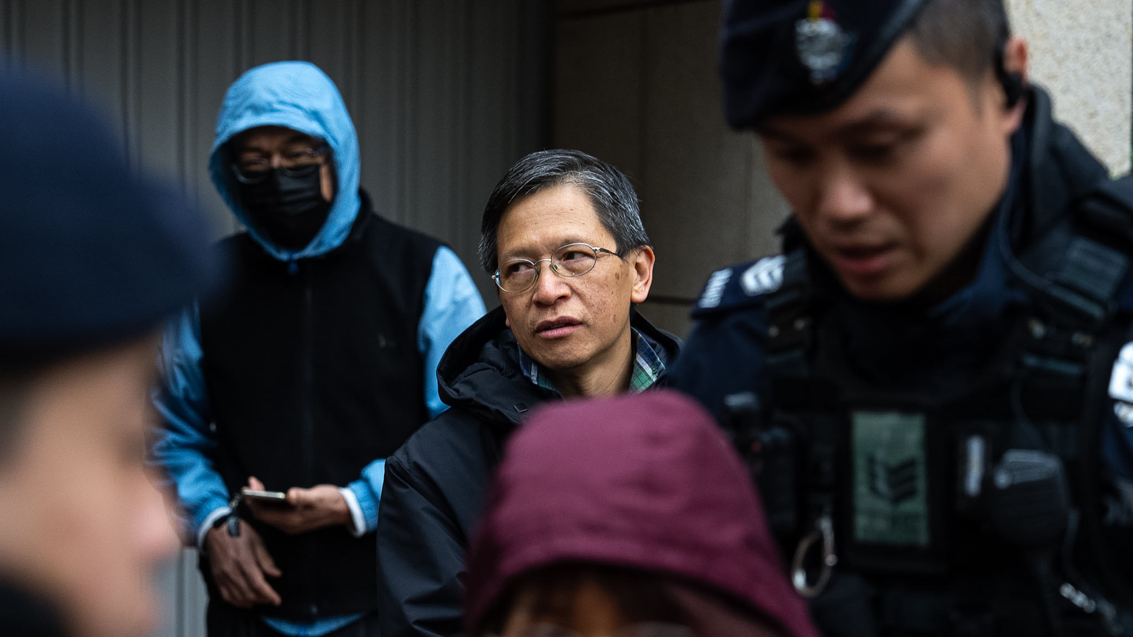 Pro-democracy activist Tang Ngok-kwan waits outside the West Kowloon Magistrates' Courts to attend a trial under a China-imposed national security law on Thursday, Jan. 22, 2026, in Hong Kong. (AP Photo/Chan Long Hei)