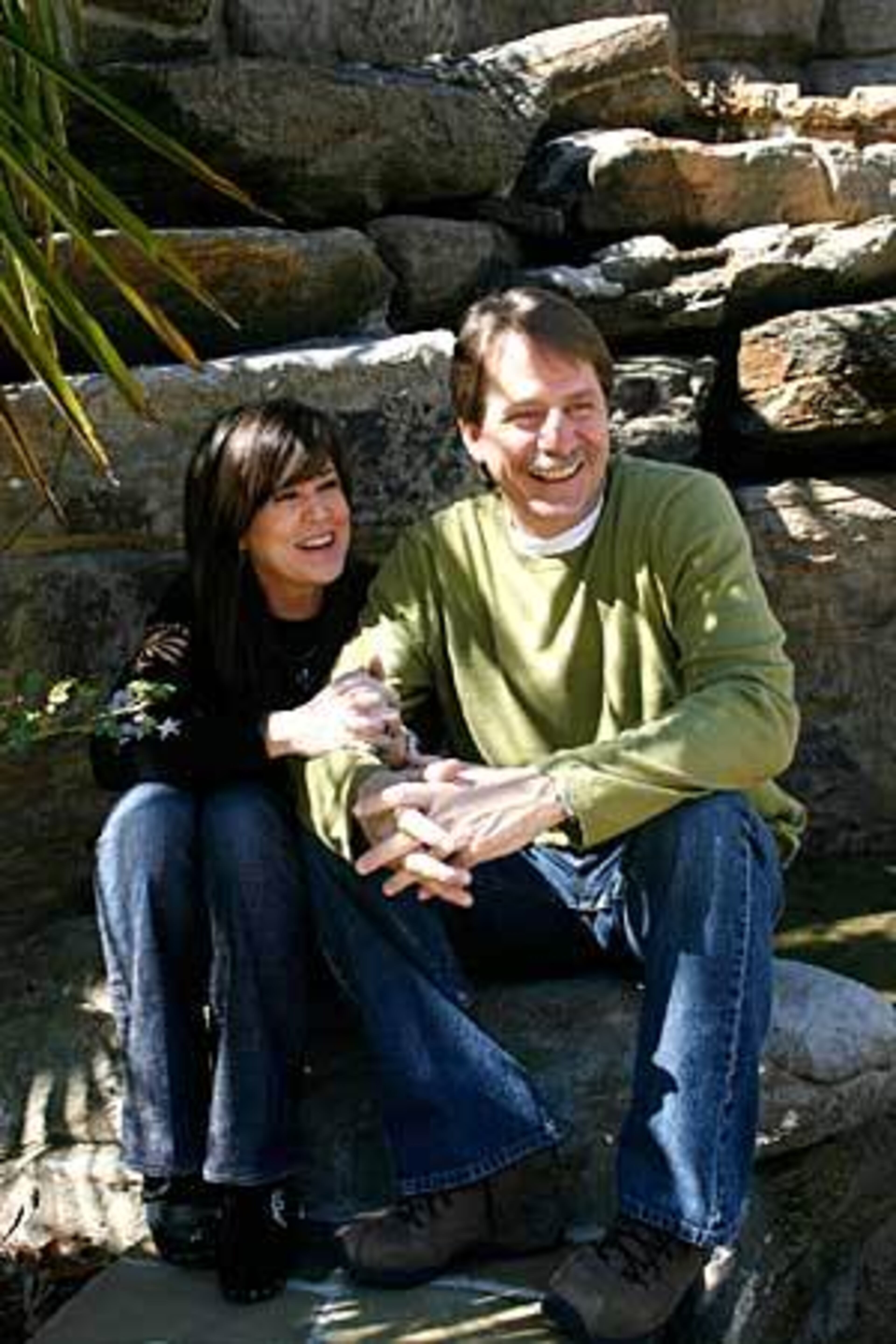 Gregg and Jeff Foxworthy enjoy some quiet time outside their Alpharetta home. The Foxworthys have two daughters. Their home is open to many family and friends on a 24-hour basis.