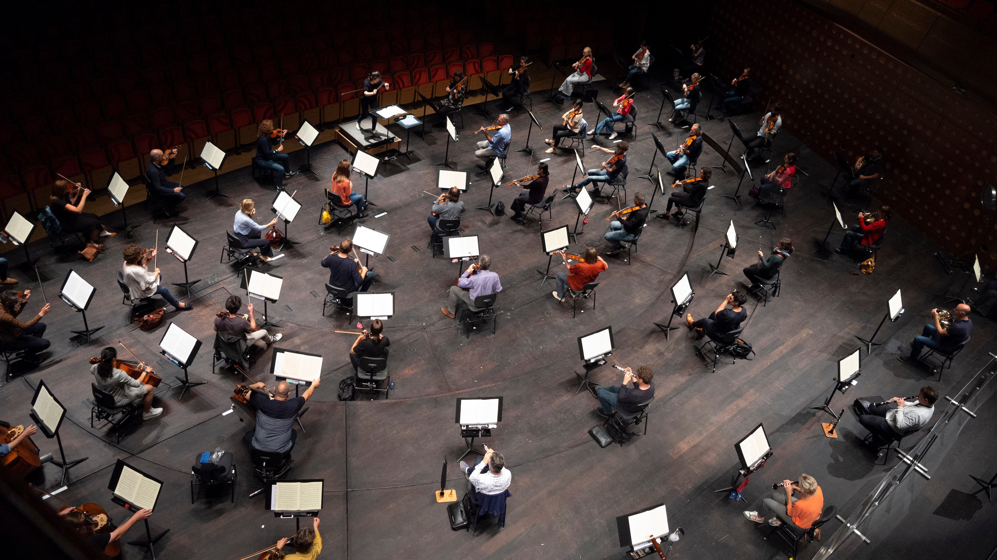 FILE - Chief Conductor Elim Chan, center top, conducts the Antwerp Symphony Orchestra through a rehearsal at the Queen Elisabeth Hall in Antwerp, Belgium, July 1, 2020. (AP Photo/Virginia Mayo, File)