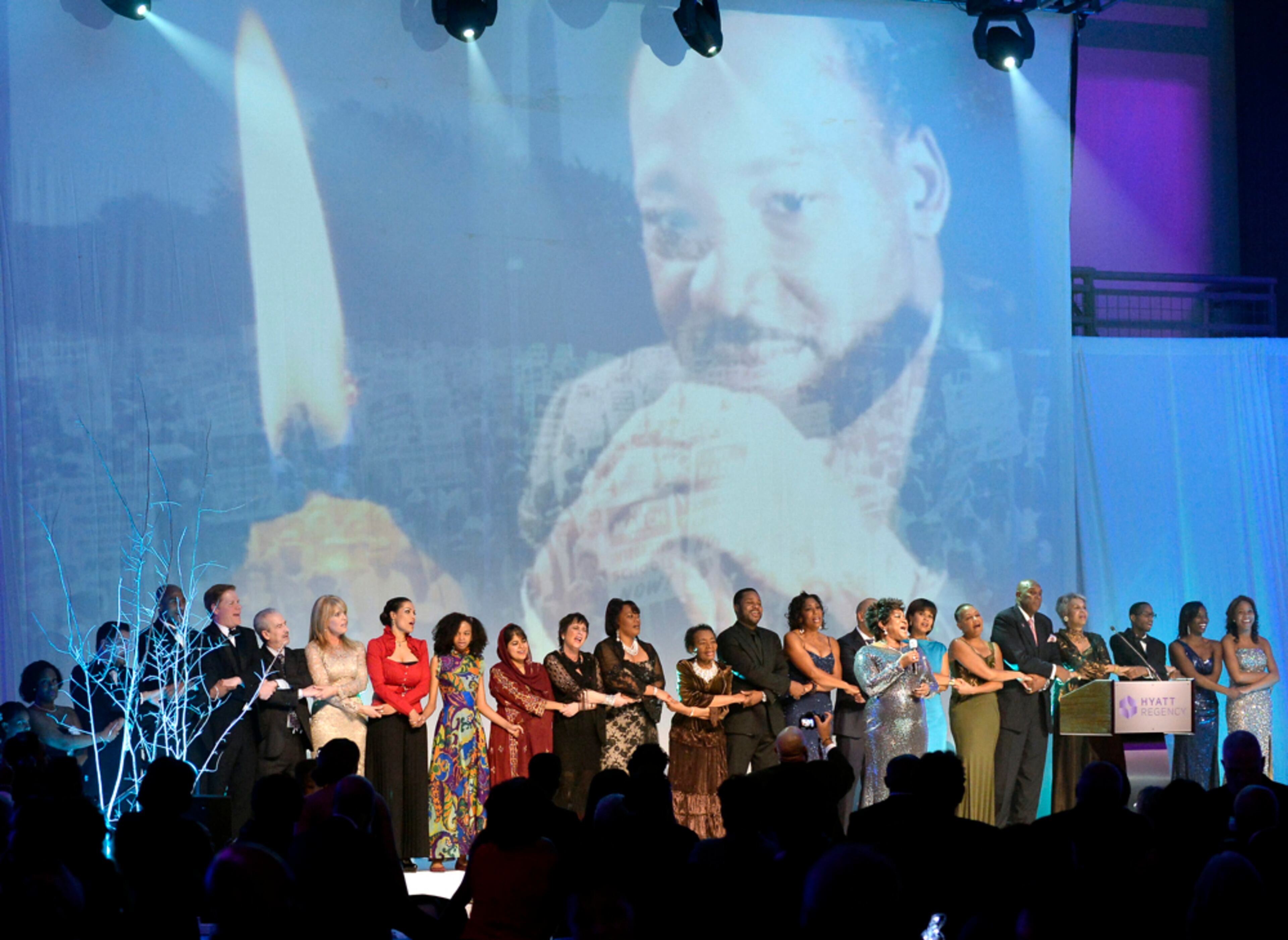 SALUTE TO GREATNESS DINNER--Guests and award winners hold hands to sing the traditional "We Shall Overcome" anthem to end the annual Salute to Greatness Awards Dinner honoring Martin Luther King Jr.'s nonviolence movement on Saturday, Jan. 18, 2014, in Atlanta. David Tulis / AJC Special