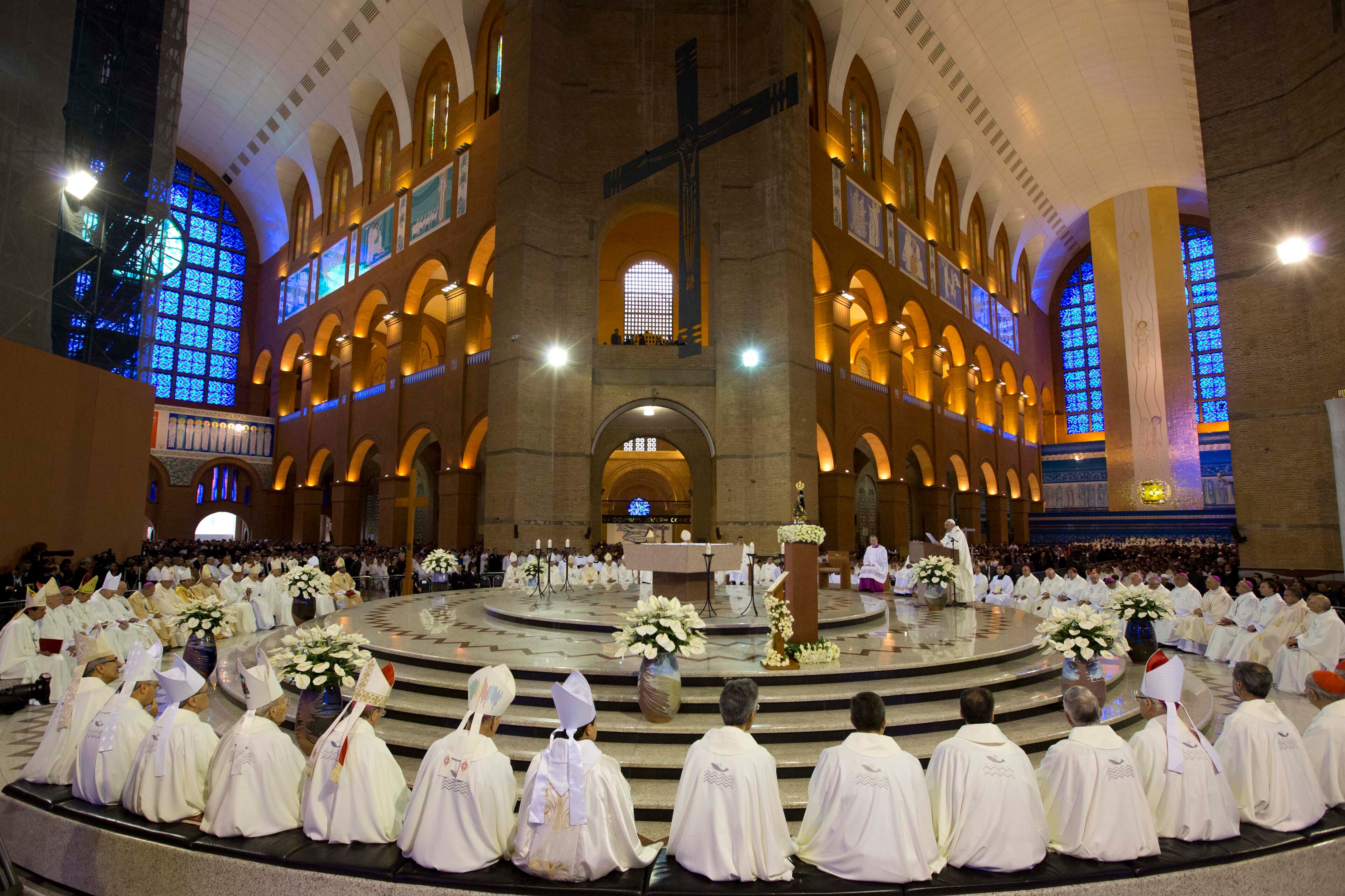 Members of the clergy listen to Pope Francis, center right, as he gives Mass inside Aparecida Basilica in Aparecida, Brazil, Wednesday, July 24, 2013. Francis celebrated the first public Mass of his trip to Brazil after praying before the statue of Our Lady of Aparecida, Brazil's patron saint. (AP Photo/Felipe Dana)
