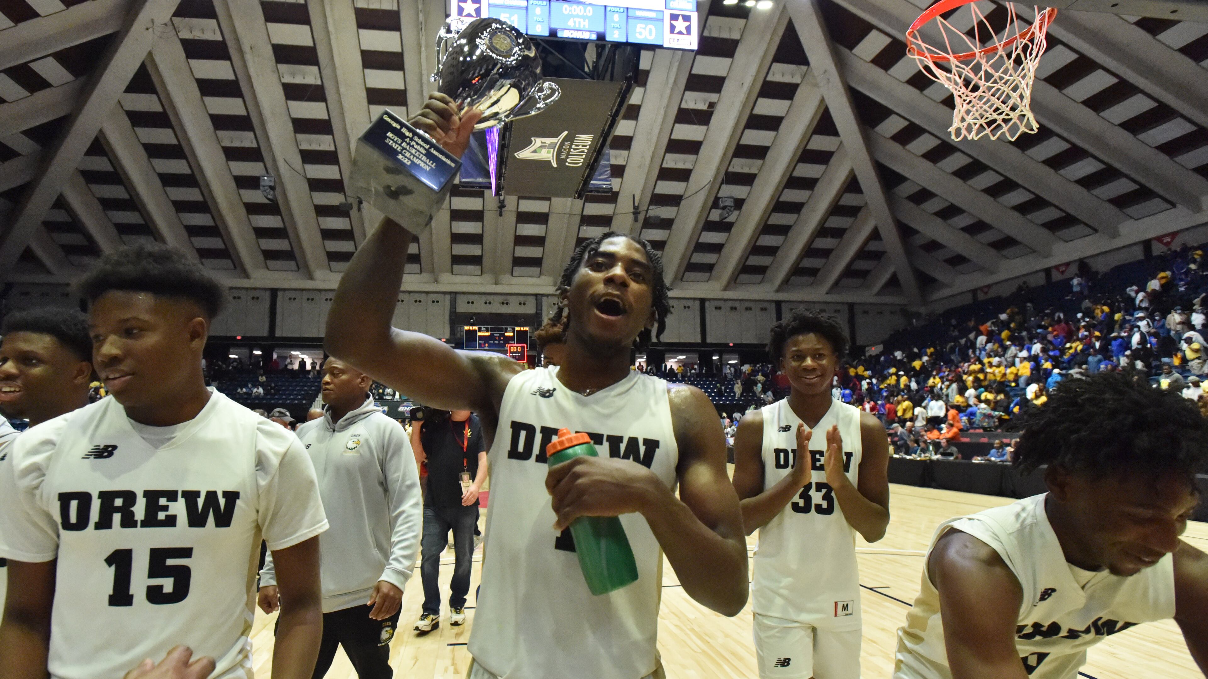 Drew Charter players celebrate after their victory in the Class A Public state title game Wednesday in Macon. Drew Charter edged Warren County 51-50. (Hyosub Shin/hshin@ajc.com)