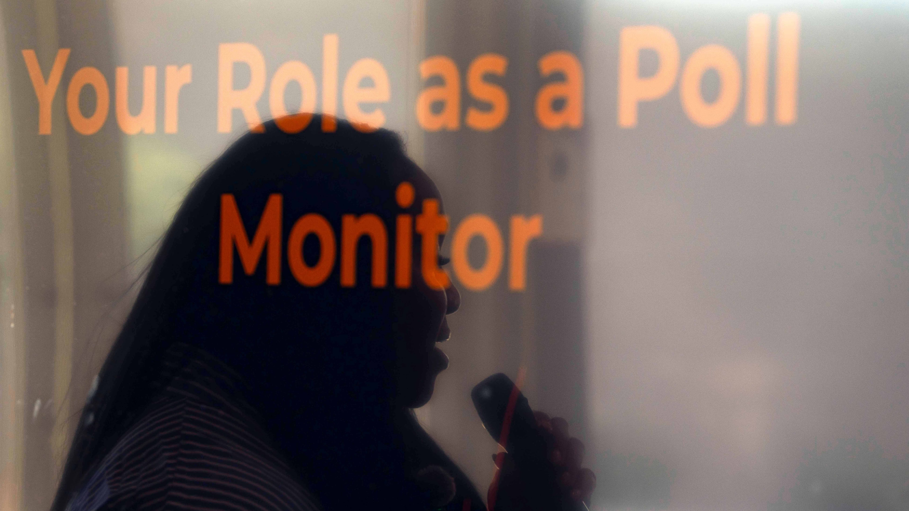 Rev. Medina Moore, an Arizona Faith Network voting rights organizer, is reflected on a television screen during a training for poll chaplains and peacekeepers, Tuesday, Oct. 6, 2026, ahead of the upcoming general midterm election, at Temple Chai in Scottsdale, Ariz. (AP Photo/Rebecca Noble)