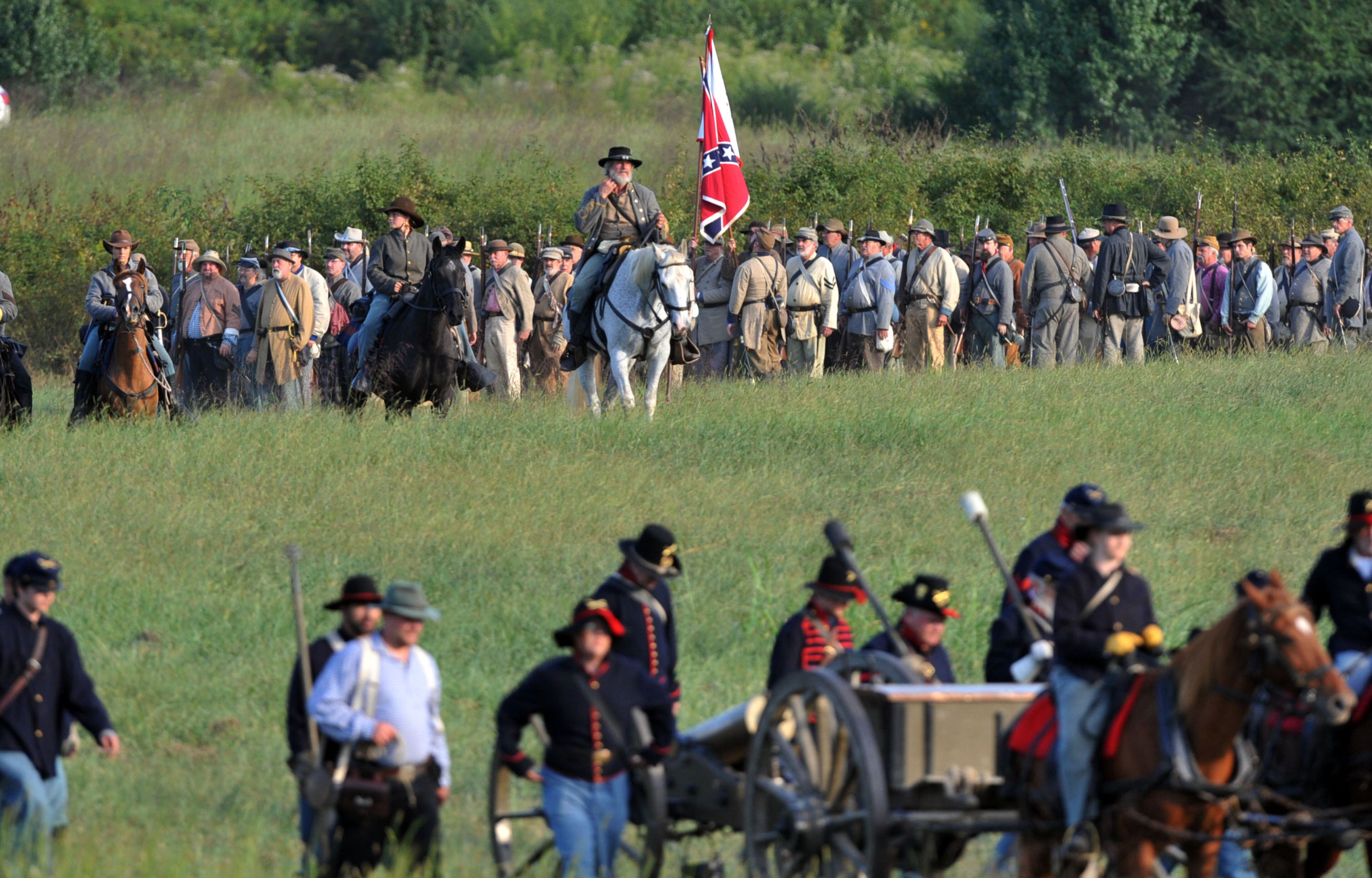 Confederate troops head to the battlefield. Confederate and Union reenactors recreate the Battle of Utoy Creek during the Atlanta Campaign's Battle of Atlanta re-enactment at the Nash Farm Battlefield Friday, September 19, 2014. Thousands of re-enactors and spectators are expected to descend on Nash Farm Battlefield for this weekend's Battle of Atlanta events starting Friday and ending Sunday afternoon. Kilpatrick's Raid, the Battle of Cheatham's Hill, and Battle of Atlanta will be reenacted Saturday and Sunday. Confederate and Federal troops are in separate encampments about a 1/2 mile apart at the site. KENT D. JOHNSON / KDJOHNSON@AJC.COM
