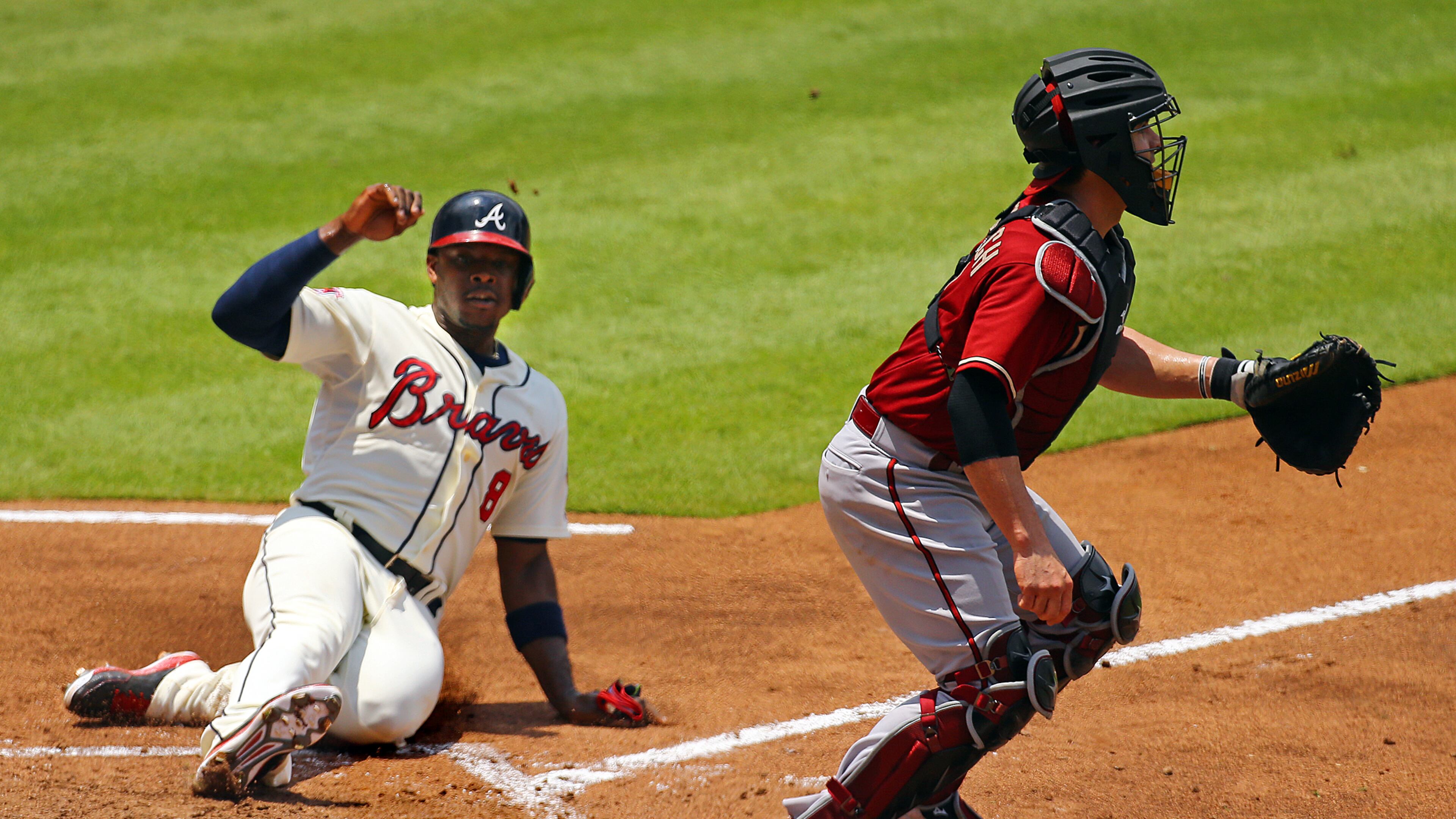 Braves Justin Upton scores on a RBI single by Chris Johnson while Diamondbacks Tuffy Gosewisch waits for the throw during the fourth inning of their MLB game on Sunday, July 6, 2014, in Atlanta. It was all the Braves would score in a 3-1 loss.