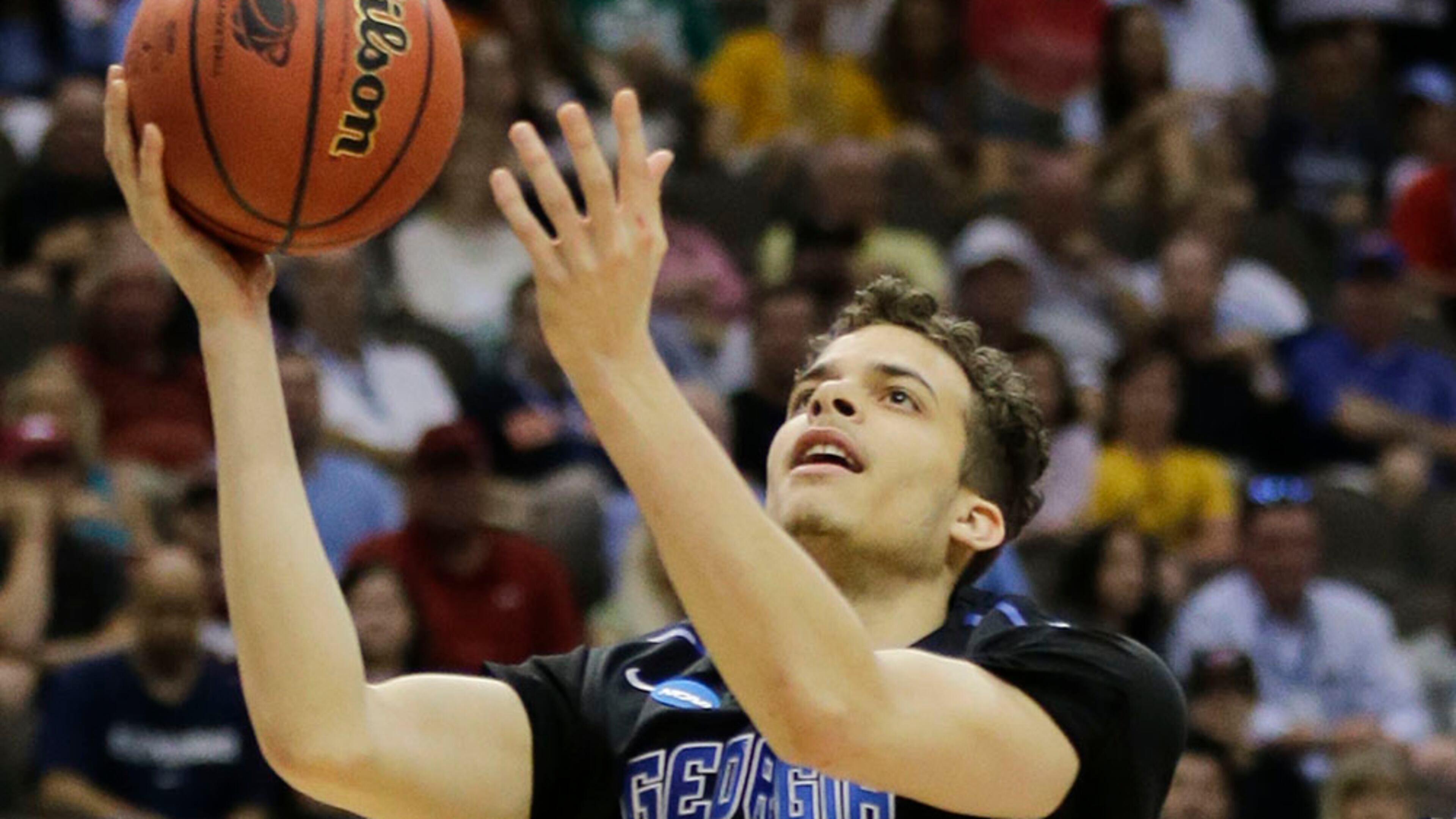 FILE - In this March 21, 2015, file photo, Georgia State guard R.J. Hunter (22) goes in for a shot between Xavier's Dee Davis, left, and Xavier's Matt Stainbrook during the first half of an NCAA tournament third round college basketball game in Jacksonville, Fla. R.J. Hunter is entering the NBA draft after making one of the most memorable shots of the NCAA tournament. Hunter announced Monday, March 30, 2015, he will give up his final year of eligibility and plans to sign with an agent shortly. (AP Photo/Chris O'Meara, File)