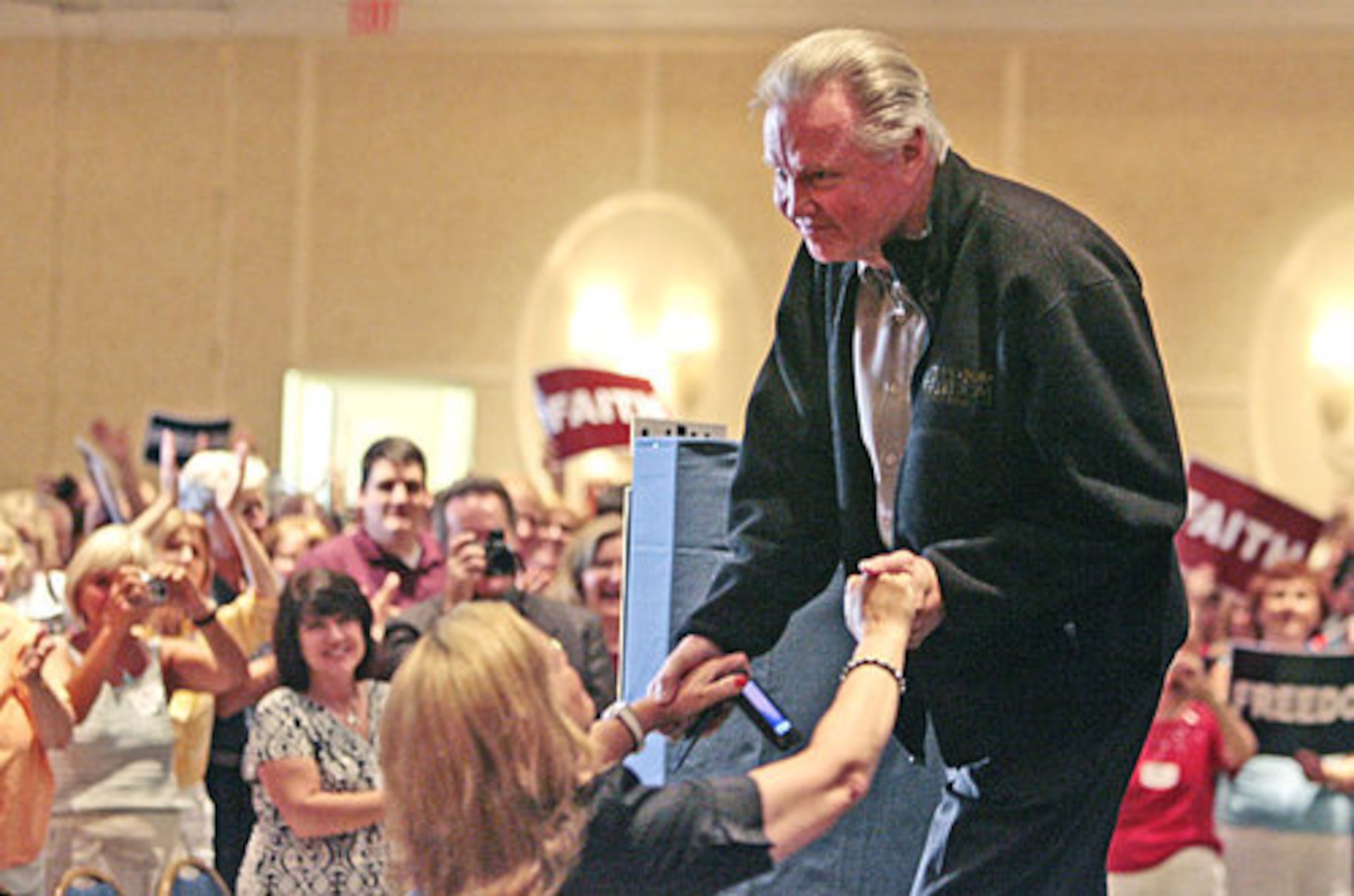 Jon Voight greets one of several women who ran up to the stage after he was introduced.