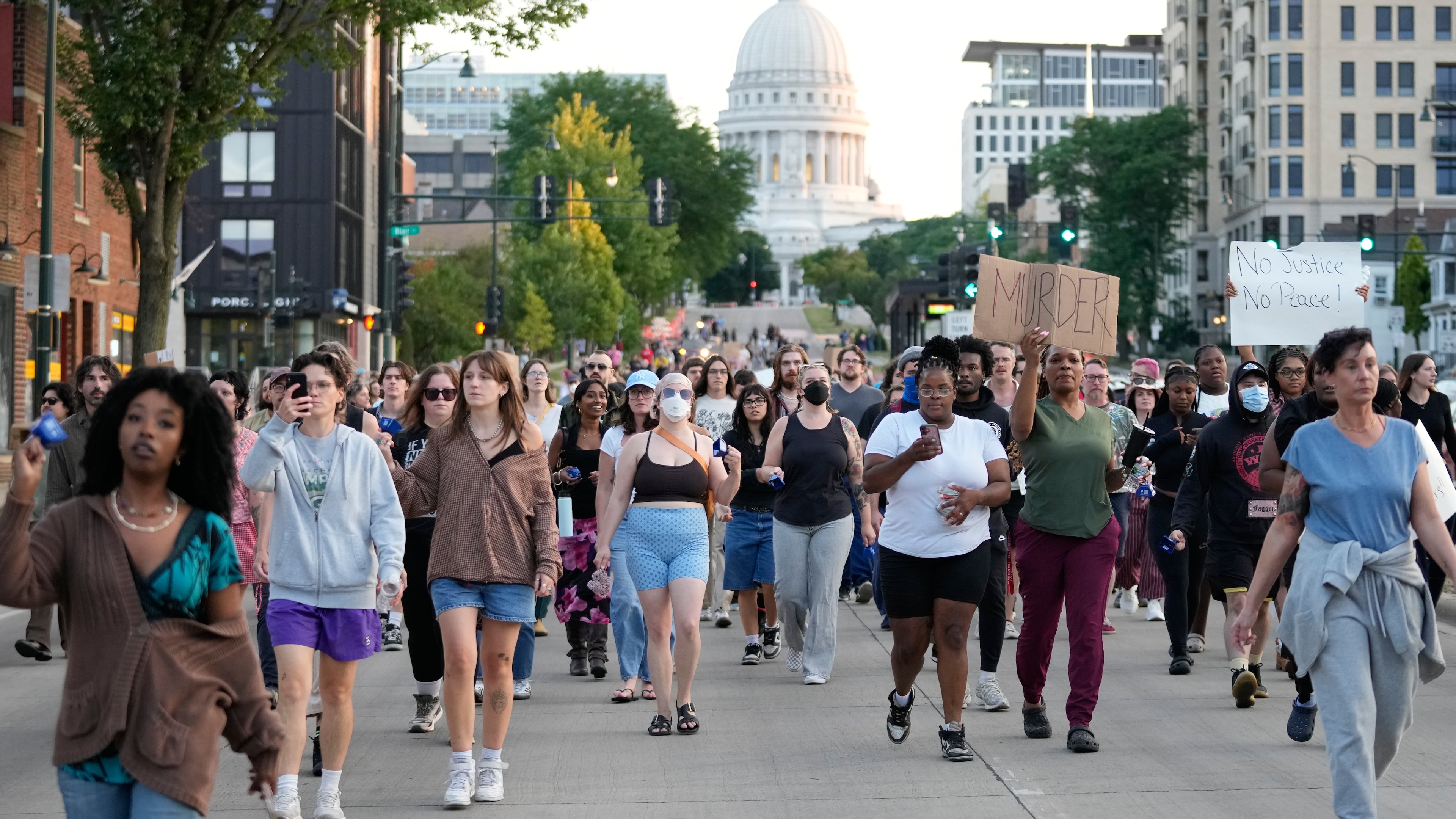 Protesters march after a Madison police officer shot and killed a man Wednesday, July 22, 2026, in Madison, Wis. (AP Photo/Kayla Wolf)