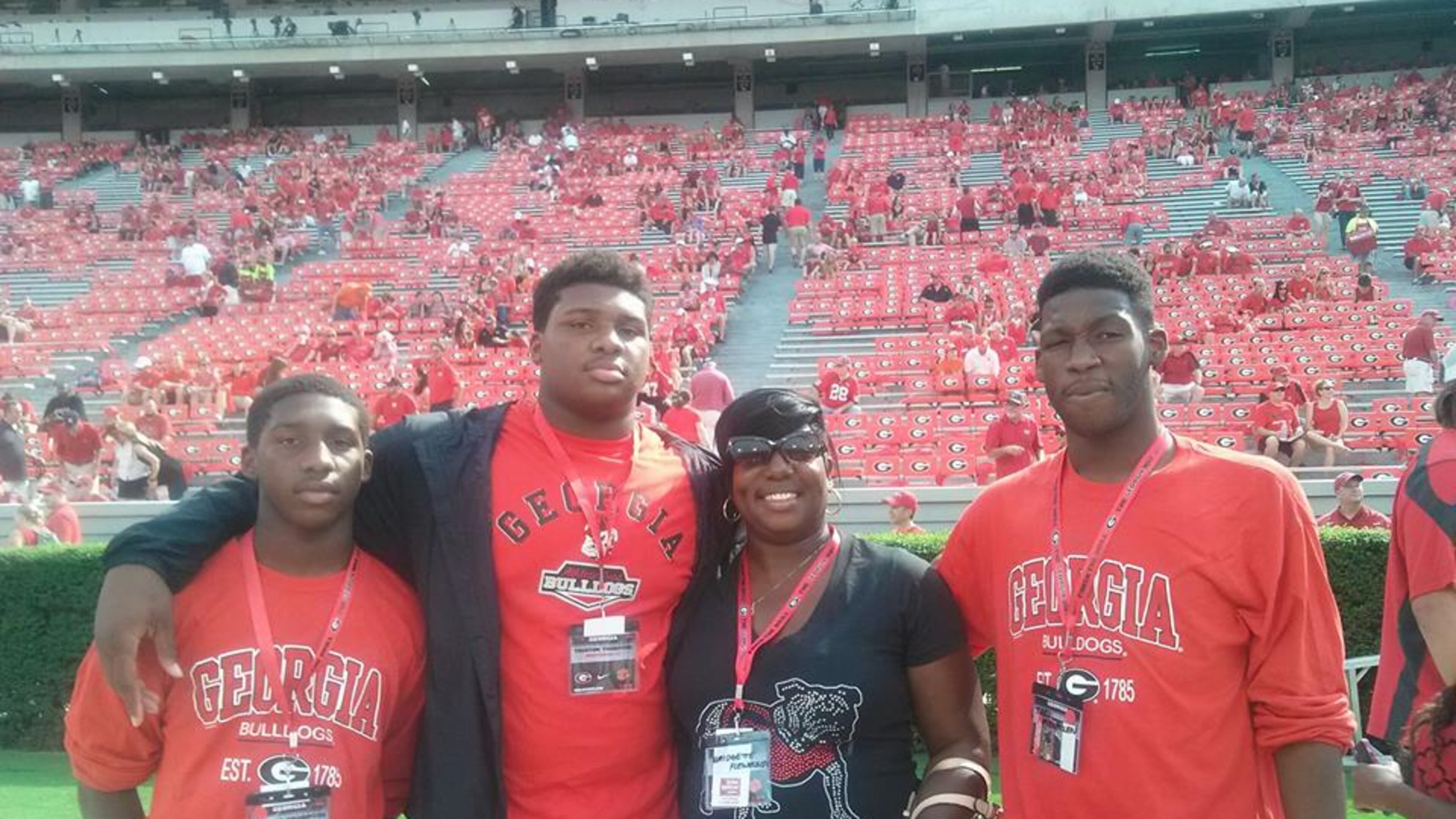 The recruiting sweepstakes for Trent Thompson took him all across the country. But his heart never left Georgia, which extended him his first offer as a high school junior. Thompson is pictured on a visit to UGA last fall with (left to right), brother Tyreck Thompson, mother Bridgette Flewellen and brother Trey Flewellen. (Special to AJC)