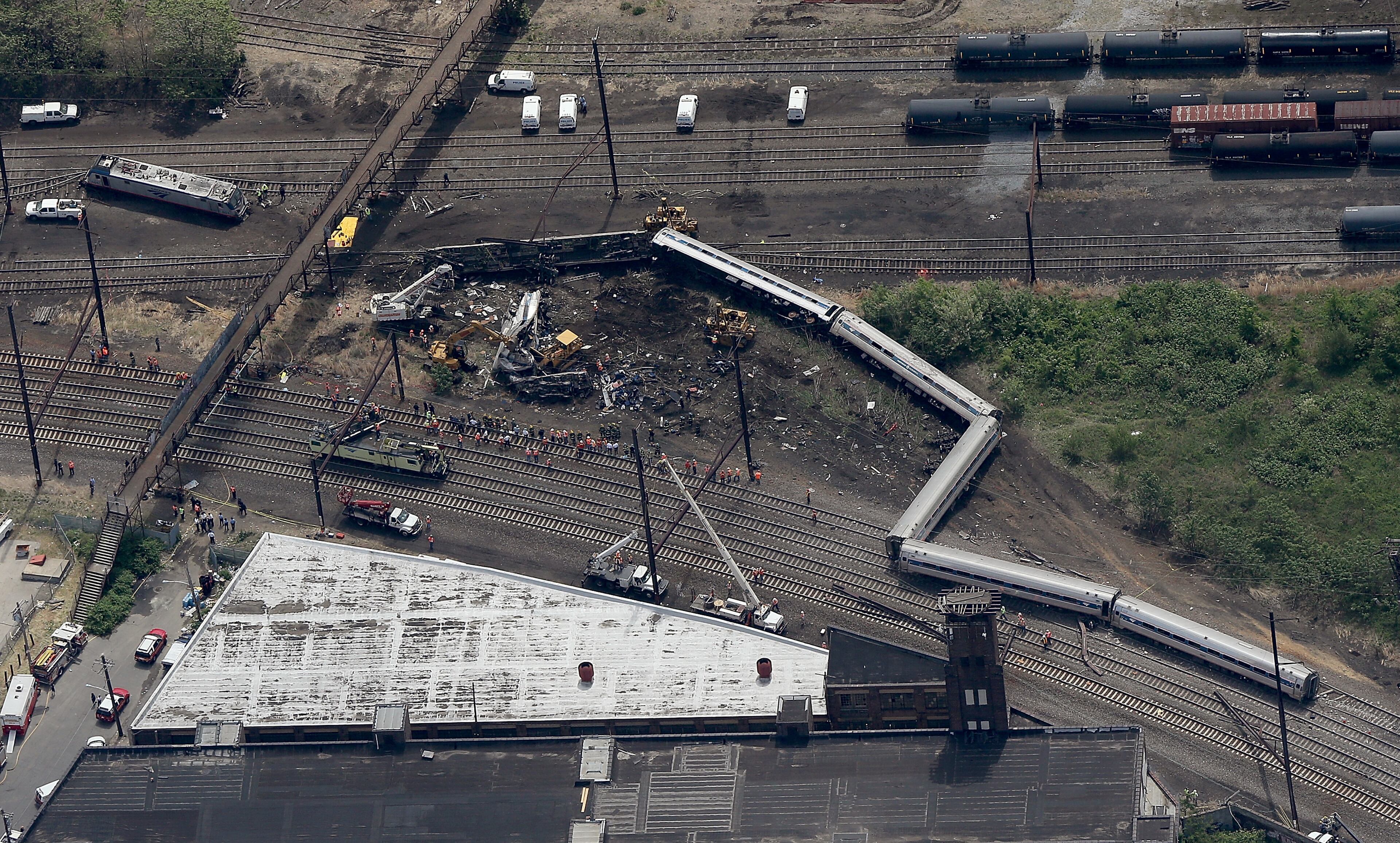 Investigators and first responders work near the wreckage of Amtrak Northeast Regional Train 188, from Washington to New York, that derailed yesterday May 13, 2015 in north Philadelphia, Pennsylvania. At least six people were killed and more than 200 others were injured in the crash. (Photo by Win McNamee/Getty Images)