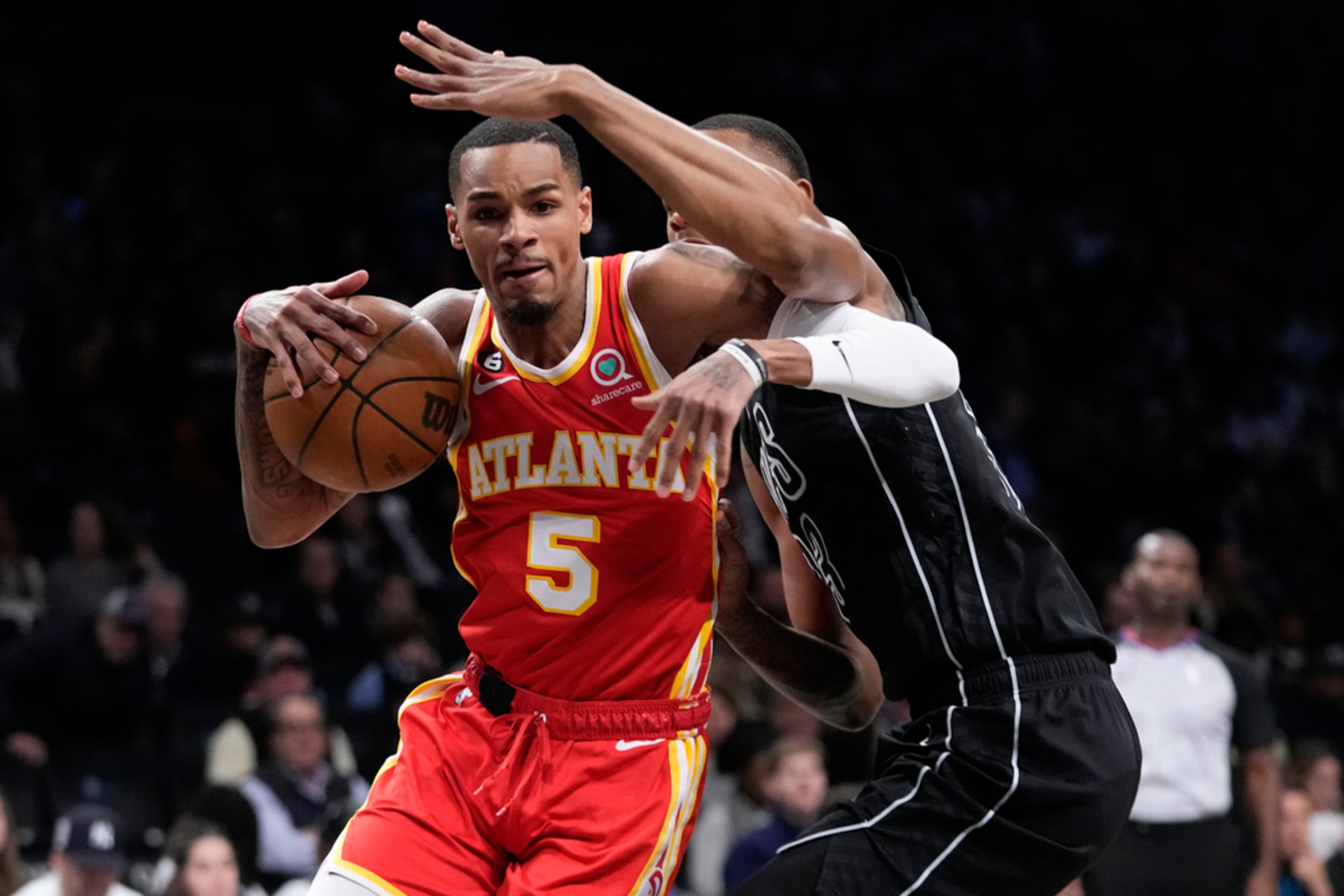 Atlanta Hawks guard Dejounte Murray (5) drives against Brooklyn Nets center Nic Claxton during the first half of an NBA basketball game Friday, March 31, 2023, in New York. (AP Photo/Mary Altaffer)