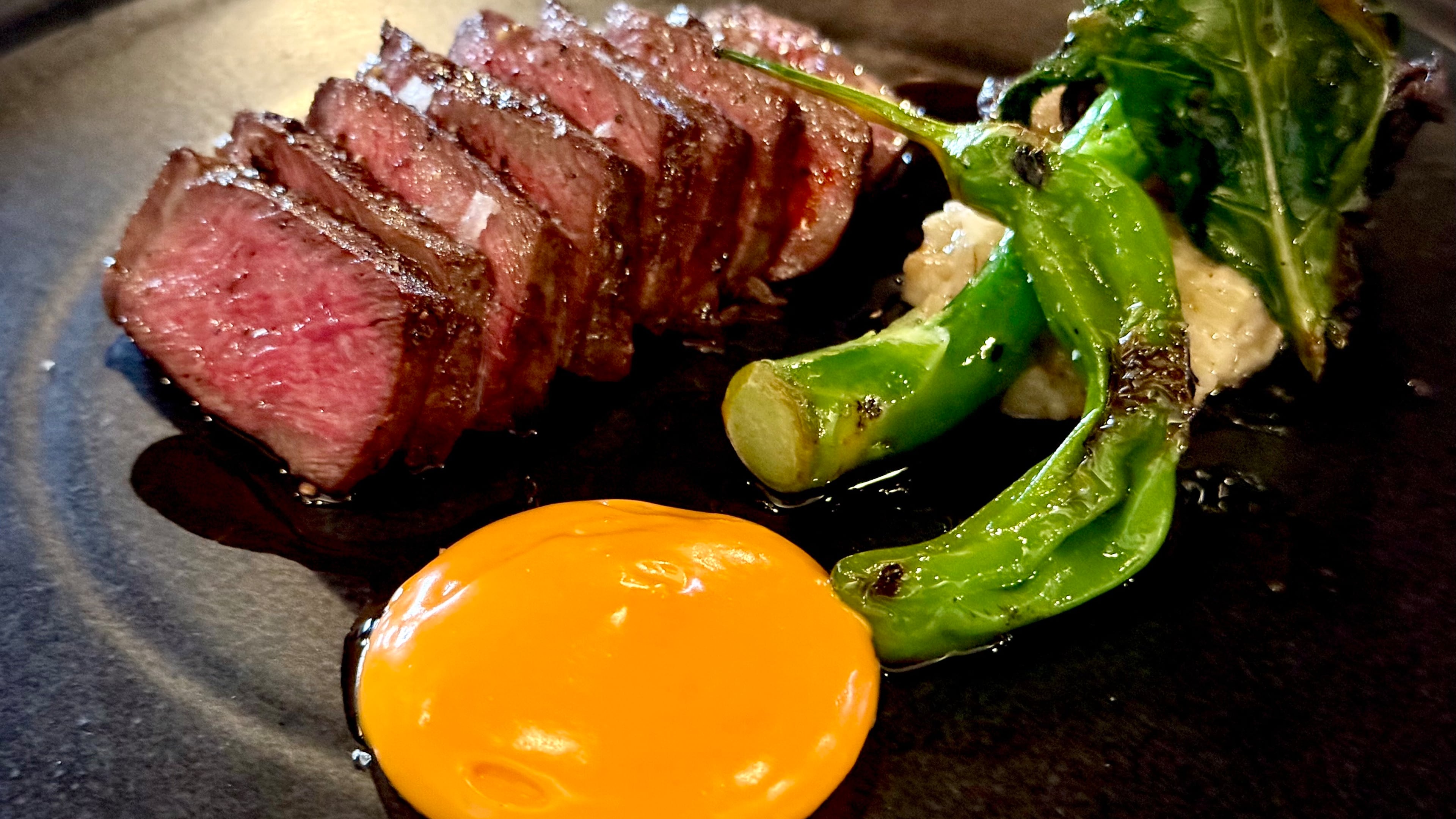 Roasted wagyu picanha with Chinese broccoli and chili sabayon is beautifully plated at Spring in Marietta. The fine-dining restaurant, which shut down last year for renovations, announced this week that it has reopened in a limited capacity. (Henri Hollis/AJC 2025)