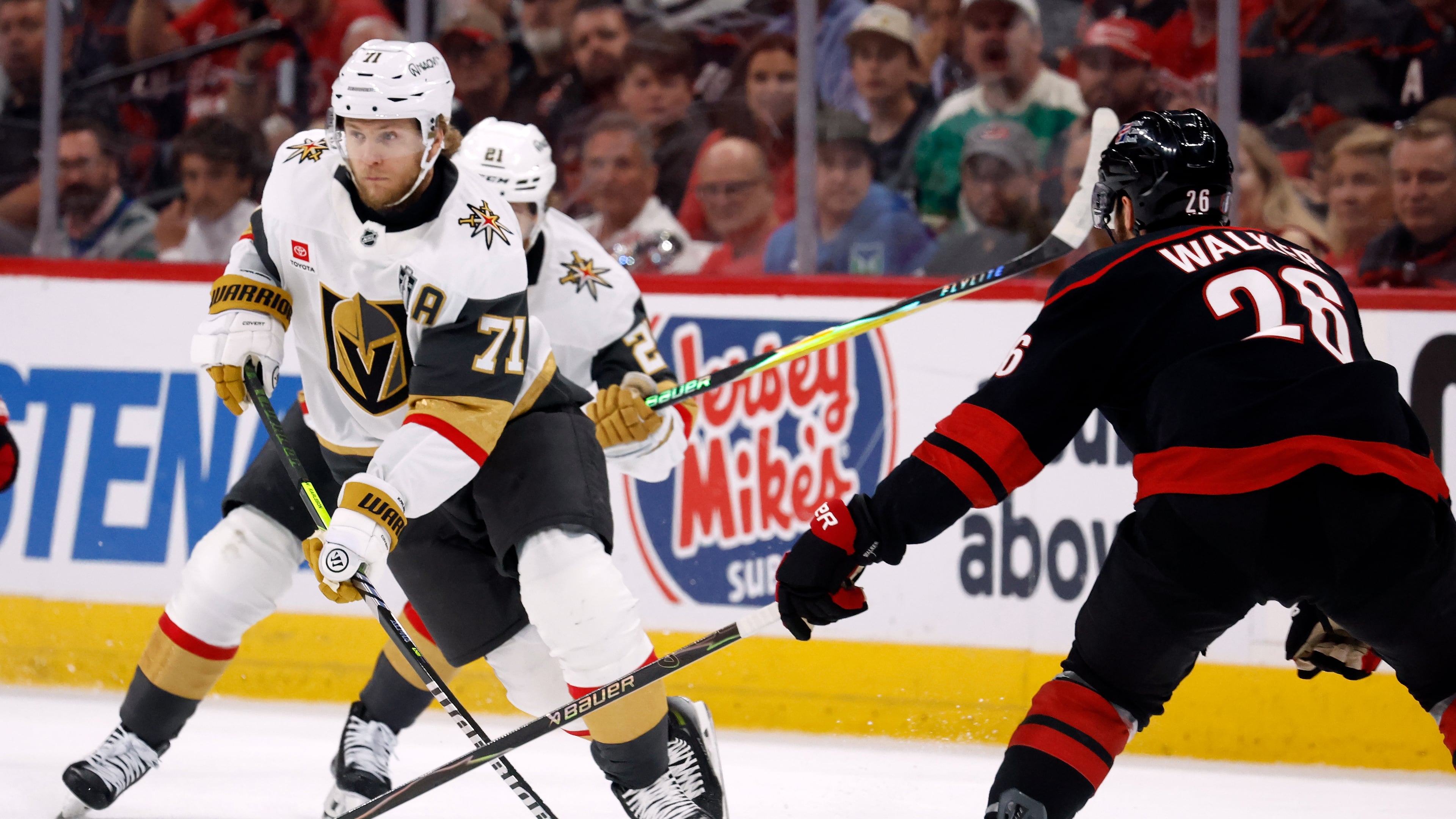 William Karlsson (71) moves the puck around Carolina Hurricanes' Sean Walker (26) during the first period in Game 5 of the NHL hockey Stanley Cup Final series in Raleigh, N.C., Thursday, June 11, 2026. (AP Photo/Karl DeBlaker)