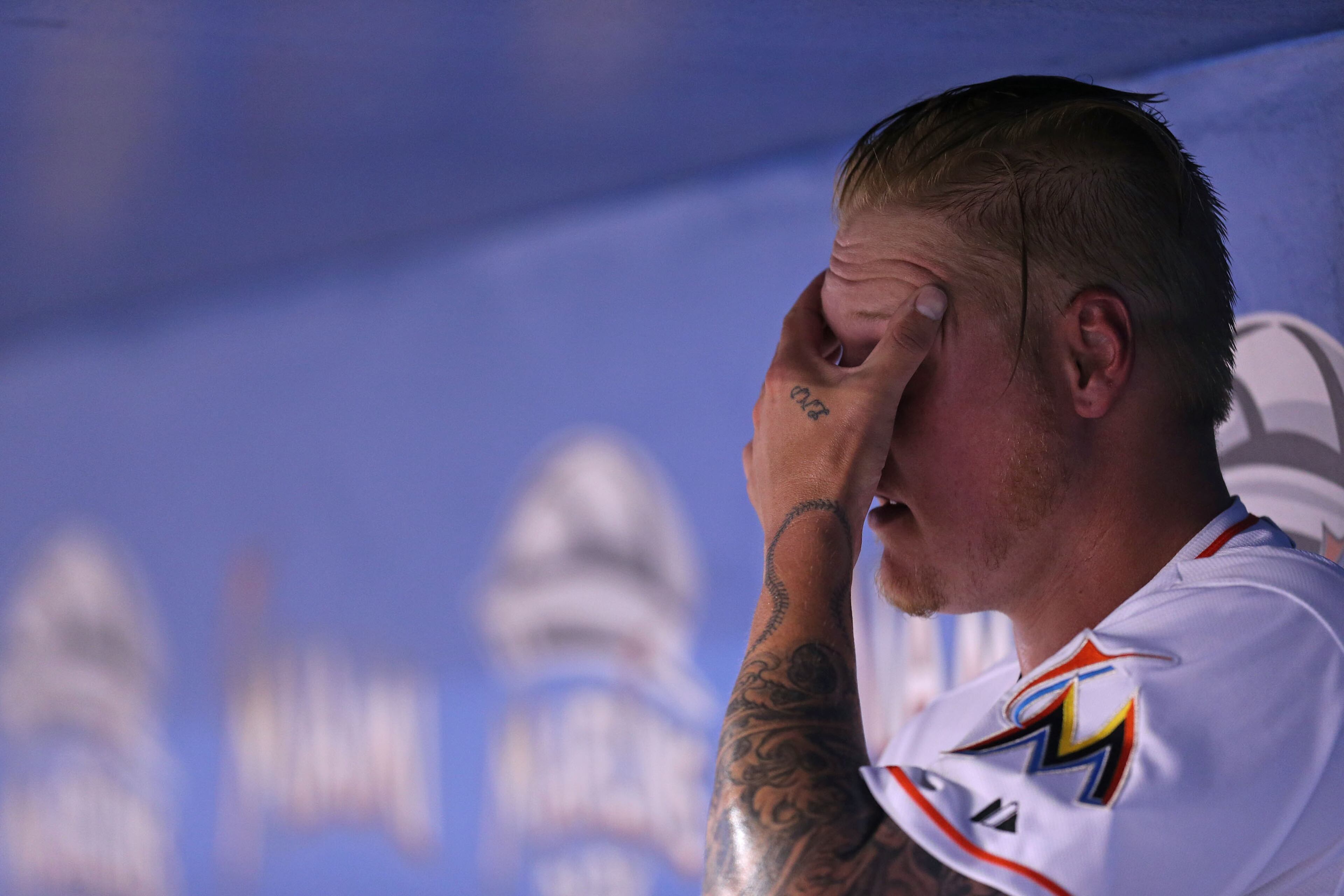 Mat Latos #35 of the Miami Marlins reacts from the dugout during the first inning of the game against the Atlanta Braves at Marlins Park on April 7, 2015 in Miami, Florida. (Photo by Rob Foldy/Getty Images)