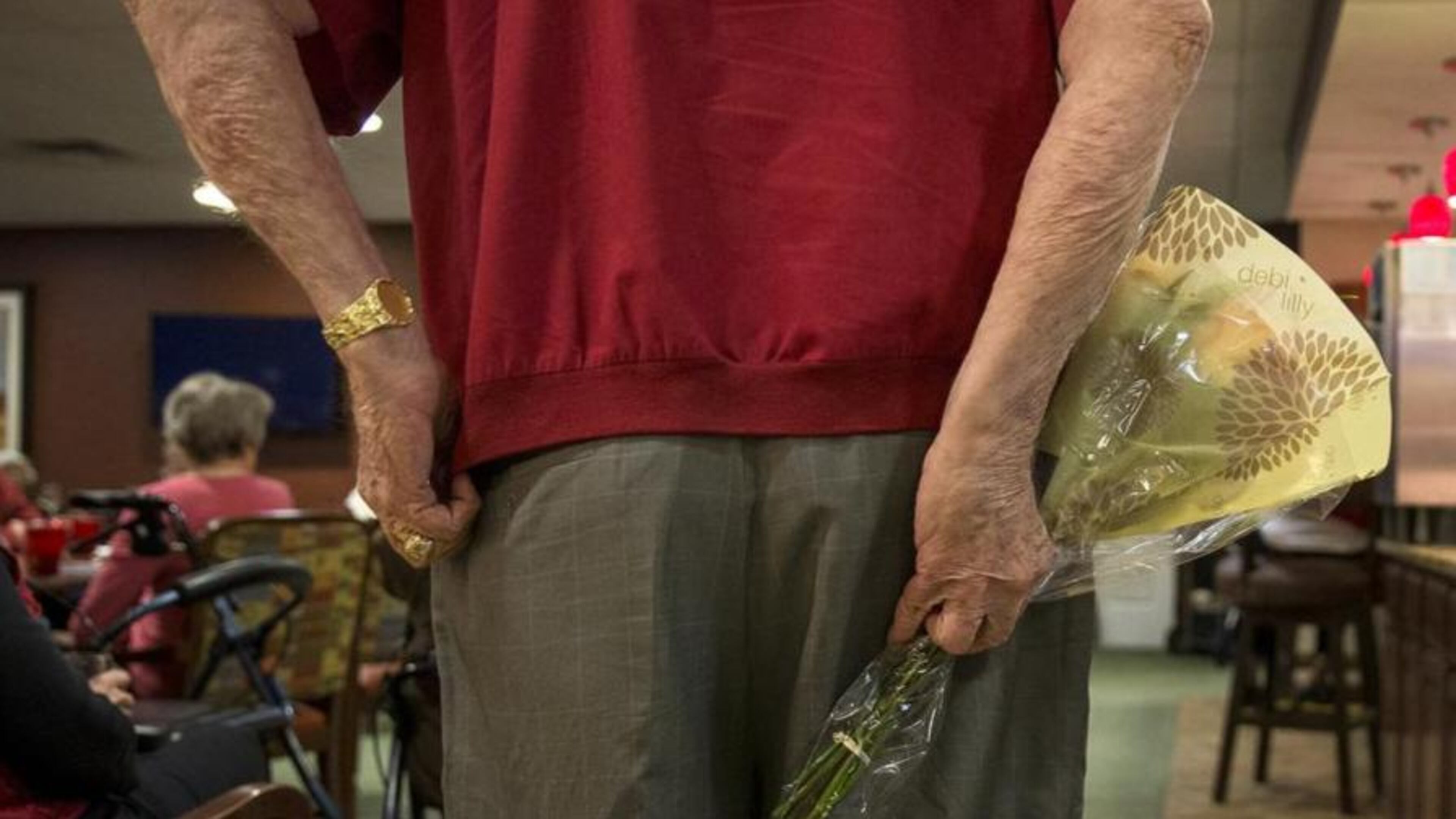 Clutching a bouquet of roses in one hand, Andy Carver searches for his “flower girl” at Lakeline Oaks Retirement Resort in Cedar Park on Feb. 2. Each Friday for the past 35 weeks, Carver has surprised a fellow resident with a bouquet of flowers. (Photo: Nick Wagner/Austin American-Statesman)