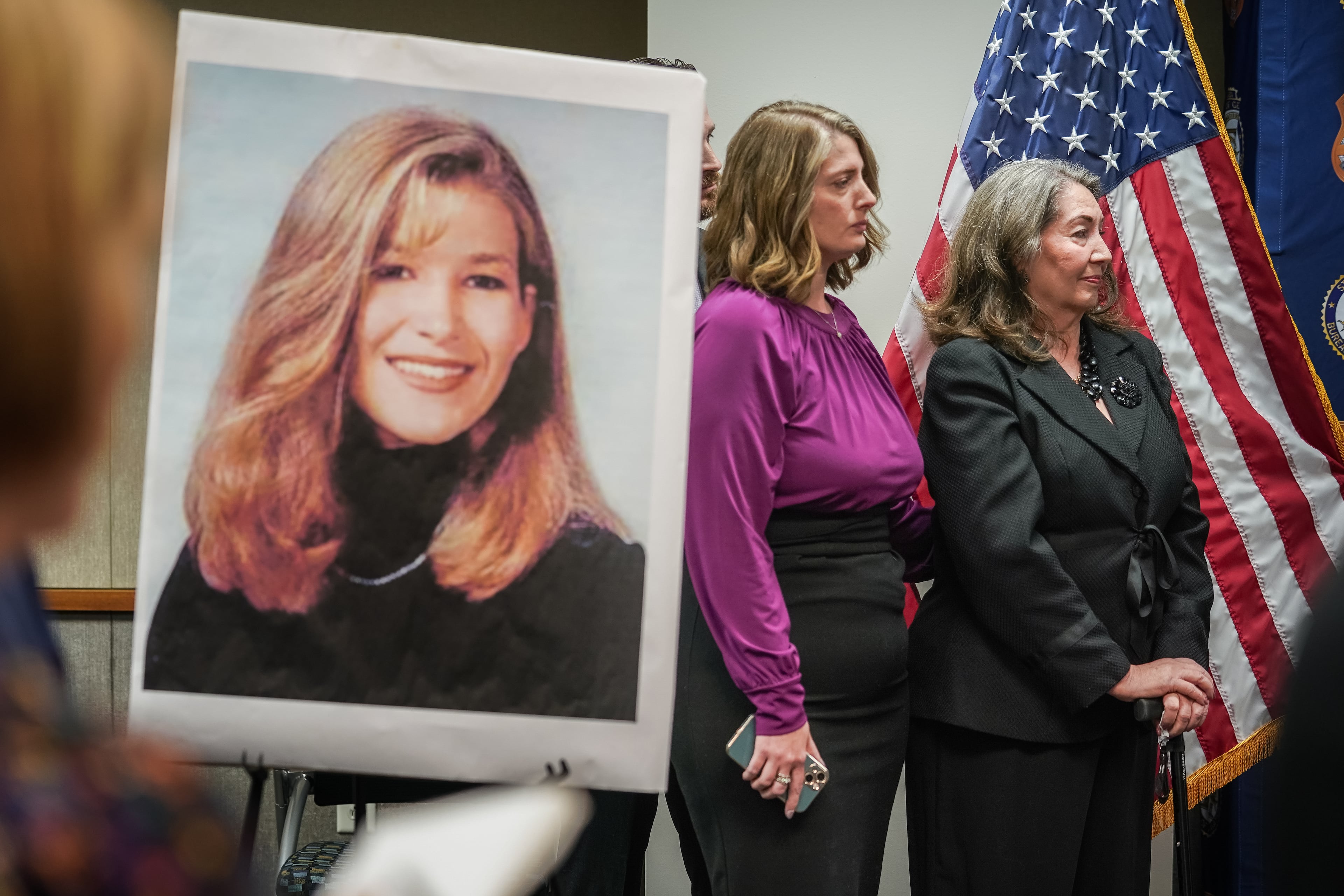 Family members of slain UGA law student Tara Louise Baker (inset photo) are seen during a press conference announcing an arrest in the 23-year-old cold case death on Monday, May 13, 2024, in Decatur. (Elijah Nouvelage for the AJC)
