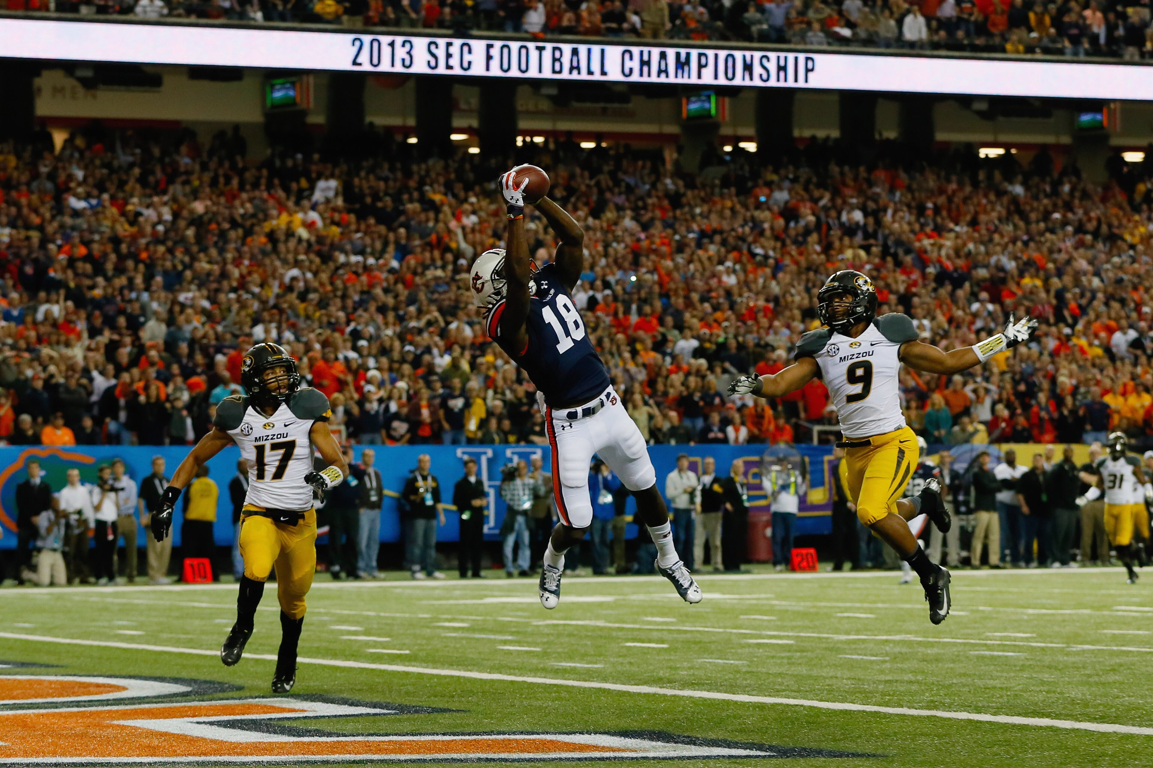 Sammie Coates (18) of the Auburn Tigers scores a touchdown against Matt White (17) and Braylon Webb (9) of the Missouri Tigers in the first quarter during the SEC Championship Game at Georgia Dome on December 7, 2013 in Atlanta. (Photo by Kevin C. Cox/Getty Images)