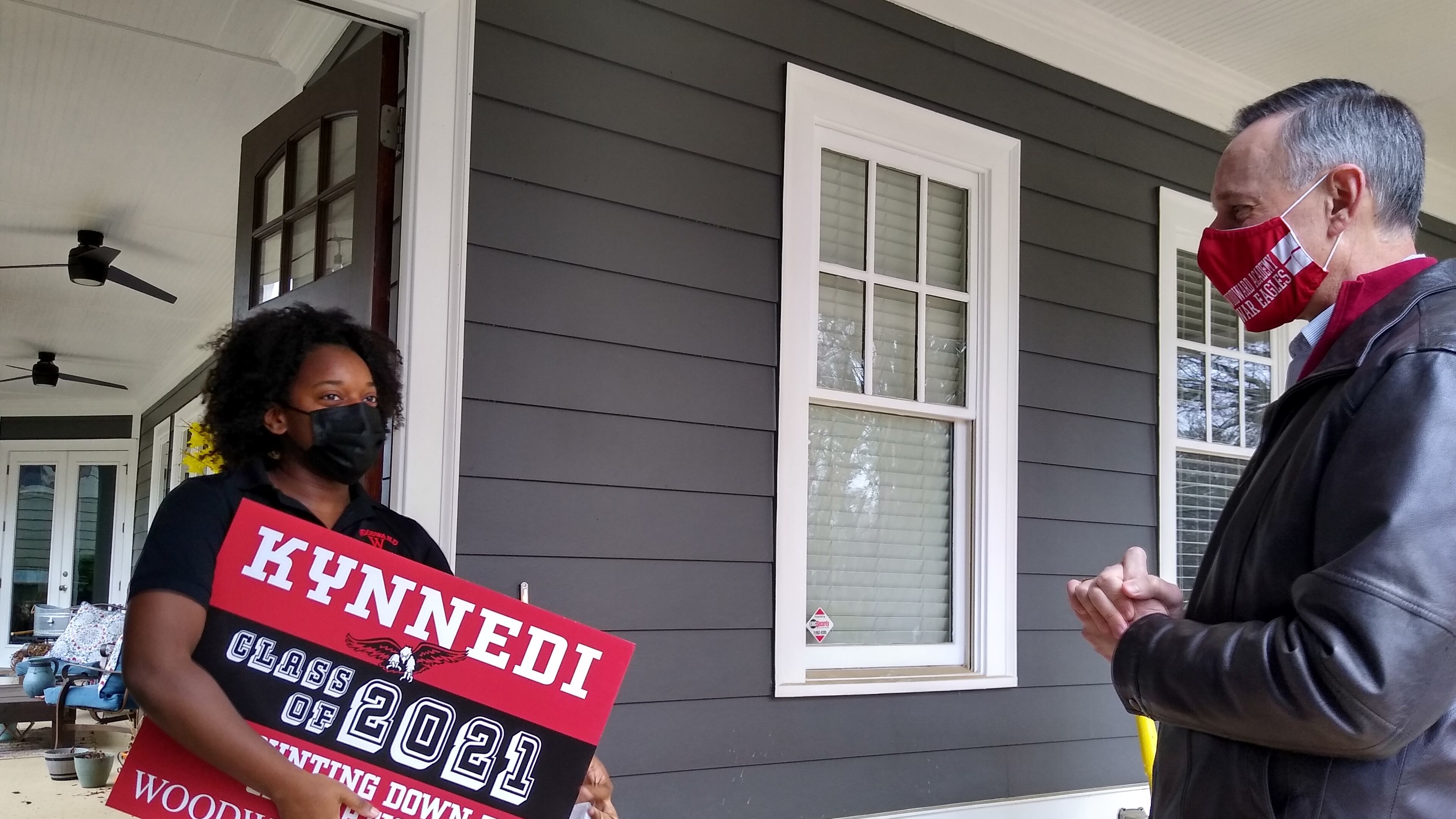 Woodward Academy senior Kynnedi Hines gets a surprise visit from the school's president, Stuart Gulley, as part of an event to personally recognize the 281 graduating seniors.