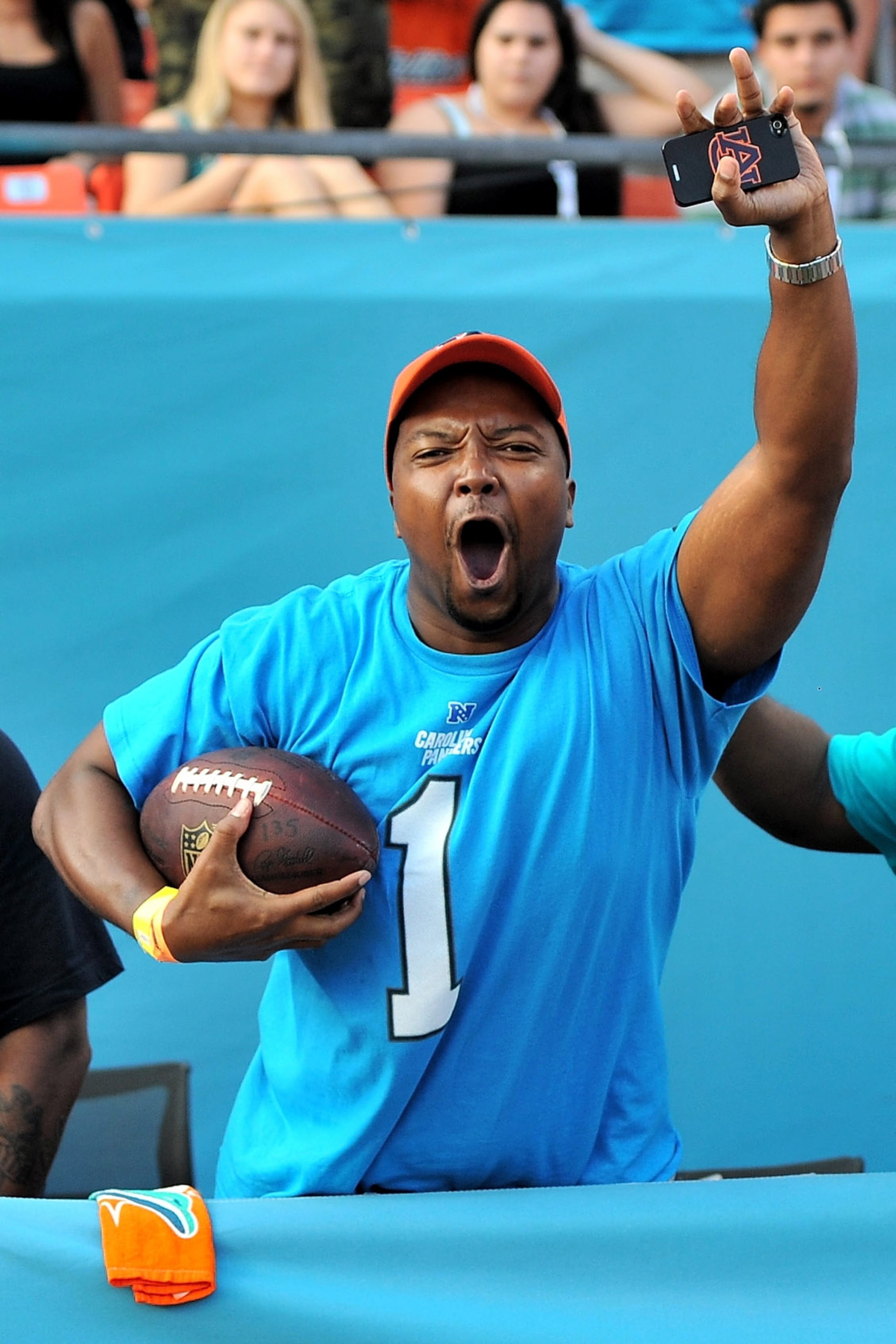 Carolina Panthers fan Kenneth Redd from Orlando reacts after receiving a football from Carolina Panthers quarterback Cam Newton (not pictured) after a touchdown during the fourth quarter against the Miami Dolphins at Sun Life Stadium. The Panthers won 20-16. Mandatory Credit: Steve Mitchell-USA TODAY Sports