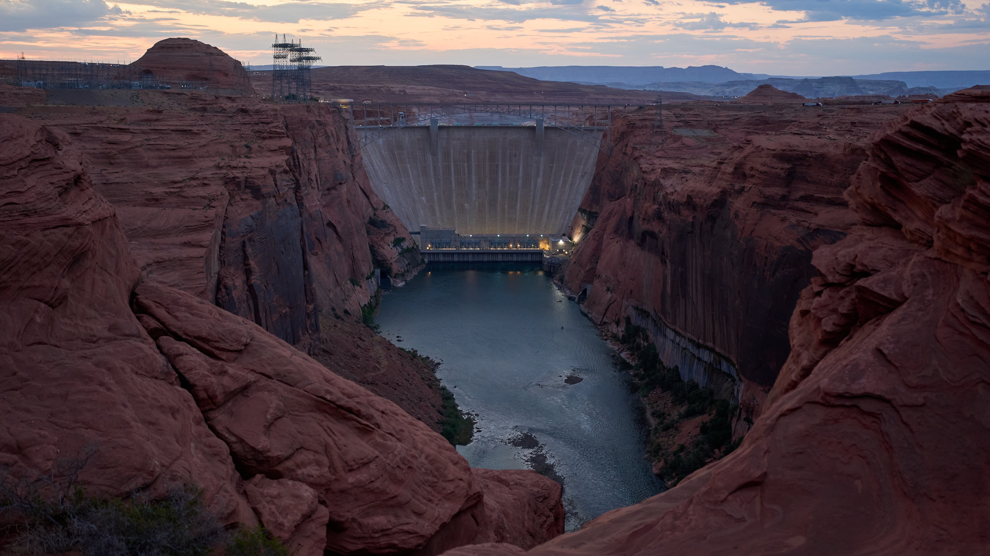 The Colorado River flows beneath the Glen Canyon Dam at the Glen Canyon National Recreation Area, Tuesday, July 14, 2026, near Page, Nev. (AP Photo/John Locher)