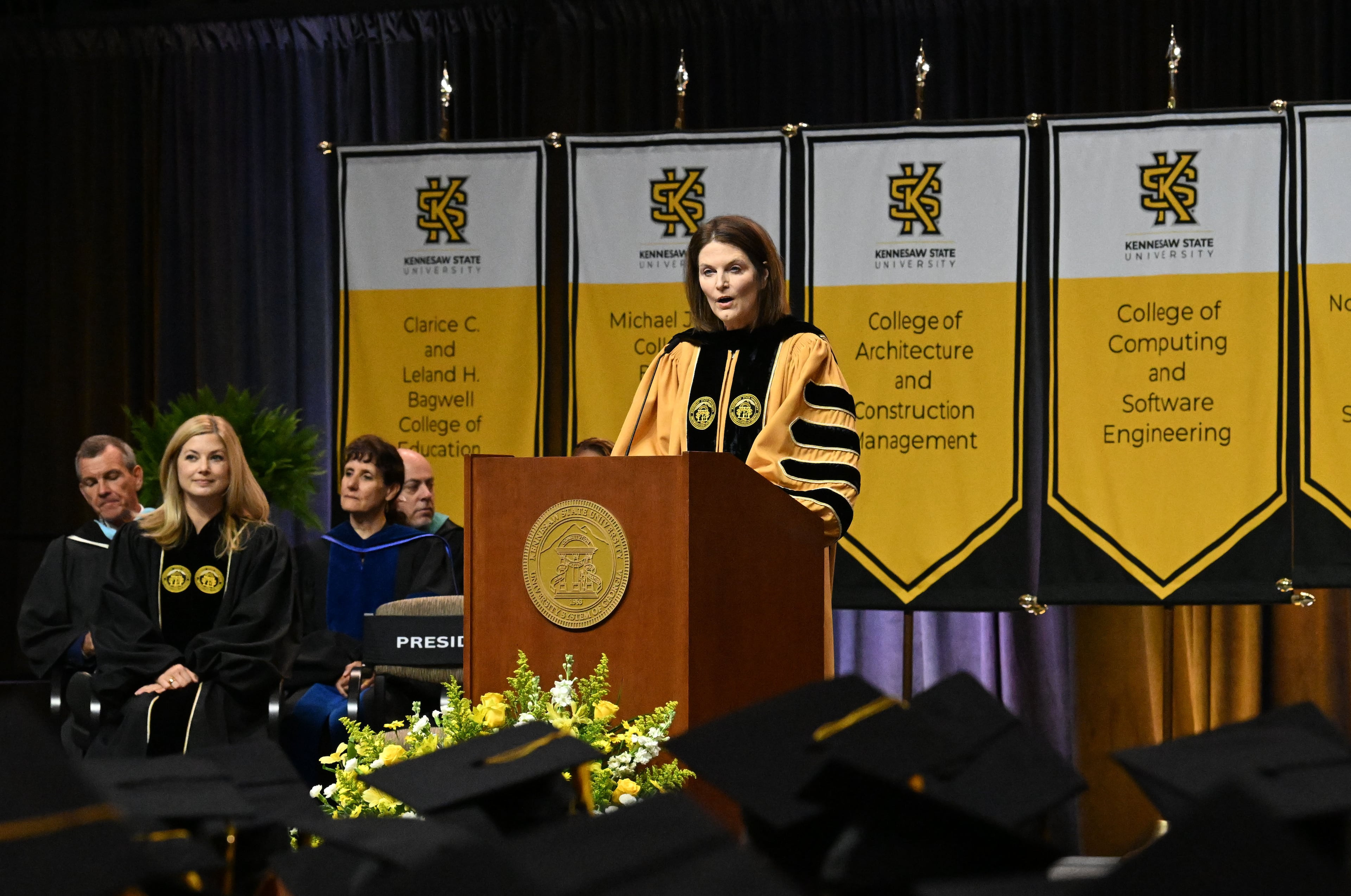 Kathy Schwaig, president of Kennesaw State University, addresses the graduates, families and friends. (Hyosub Shin/AJC)