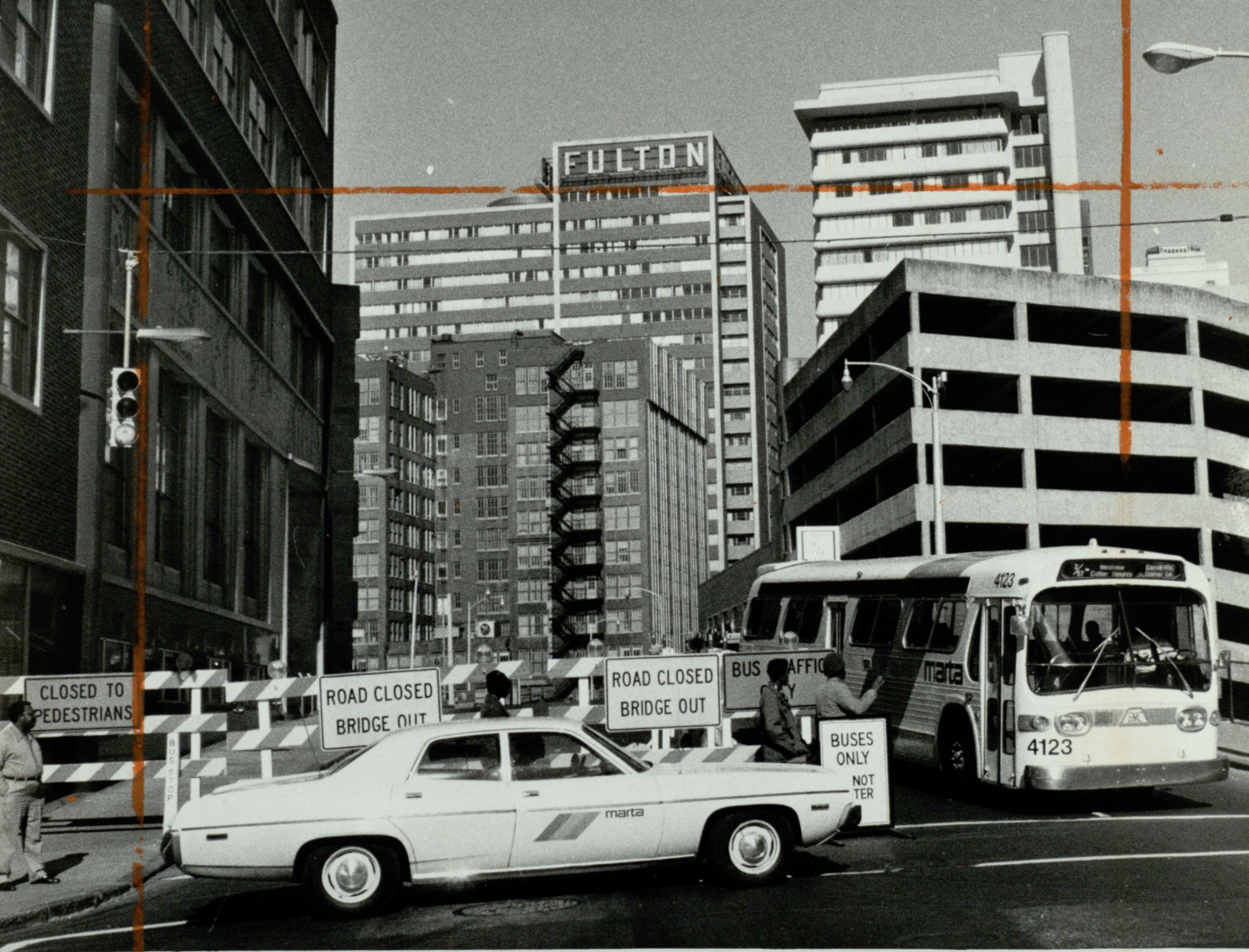 Photo taken Feb. 9, 1976. The original caption: "FORSYTH CLOSES FOR MARTA. Workmen erected these barricades at Forsyth and Alabama streets Sunday and put up similar barricades at Forsyth and Marietta streets to close off the area so that MARTA can begin construction of its Five Points Station, the hub of the coming rapid transit system. Buses will continue to operate on the one-block section until Feb. 16, when the viaduct will be completely closed so that it can be torn down. Construction on the Forsyth Street section is expected to be complete in mid-October 1976. The new viaduct will be built several feet higher to be compatible with the Five Points Station." Guy Hayes/AJC