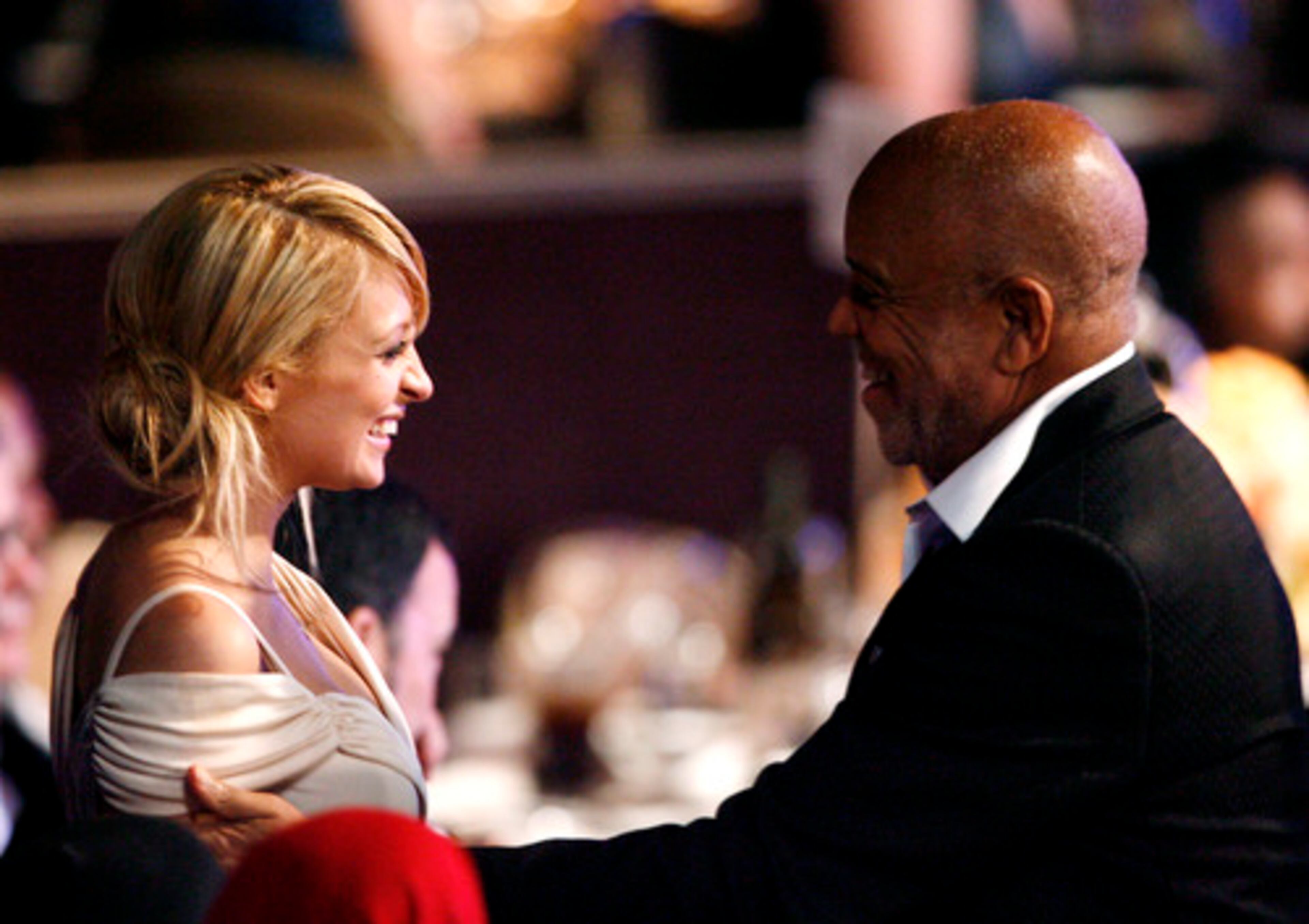 New mother Nicole Richie greets Berry Gordy. Her father, Lionel, was also at the party.
