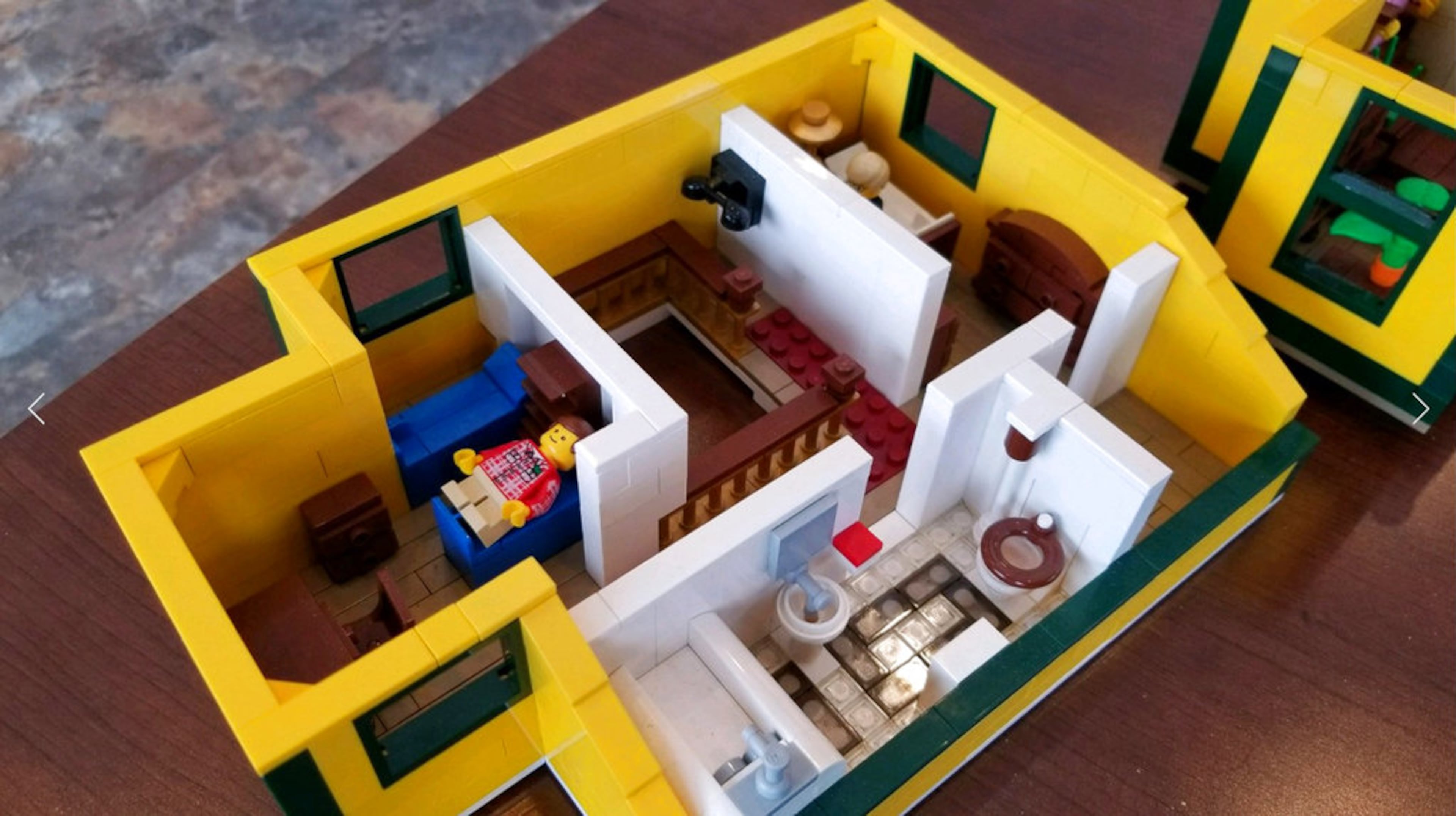 In this Dec. 12, 2017 photo provided by WSTM-TV, an interior view of a model of the house from "A Christmas Story" rests on a floor in Jason Middaugh's Marcellus, N.Y. home. WSTM-TV in Syracuse reports Middaugh's small family project to recreate the house from the classic holiday film turned into a six-month undertaking. He says he and his family scoured the internet to find the 2,000 pieces needed to construct the home. Lego reviews set proposals when 10,000 people support a project on their special site. The Middaugh family's set has received nearly 9,000 endorsements. (WSTM-TV via AP)