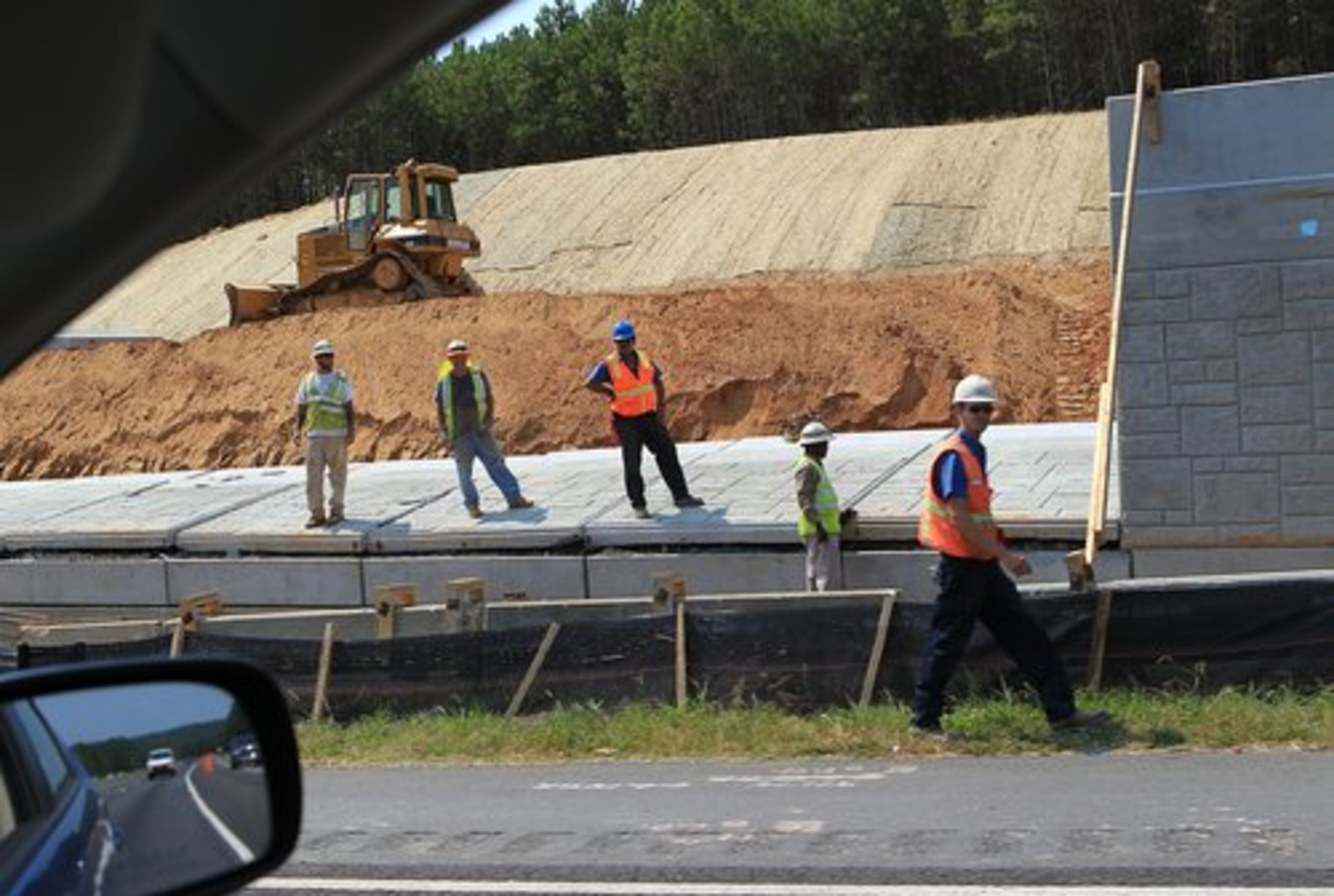 The wall fell away from the roadway, but traffic was affected.