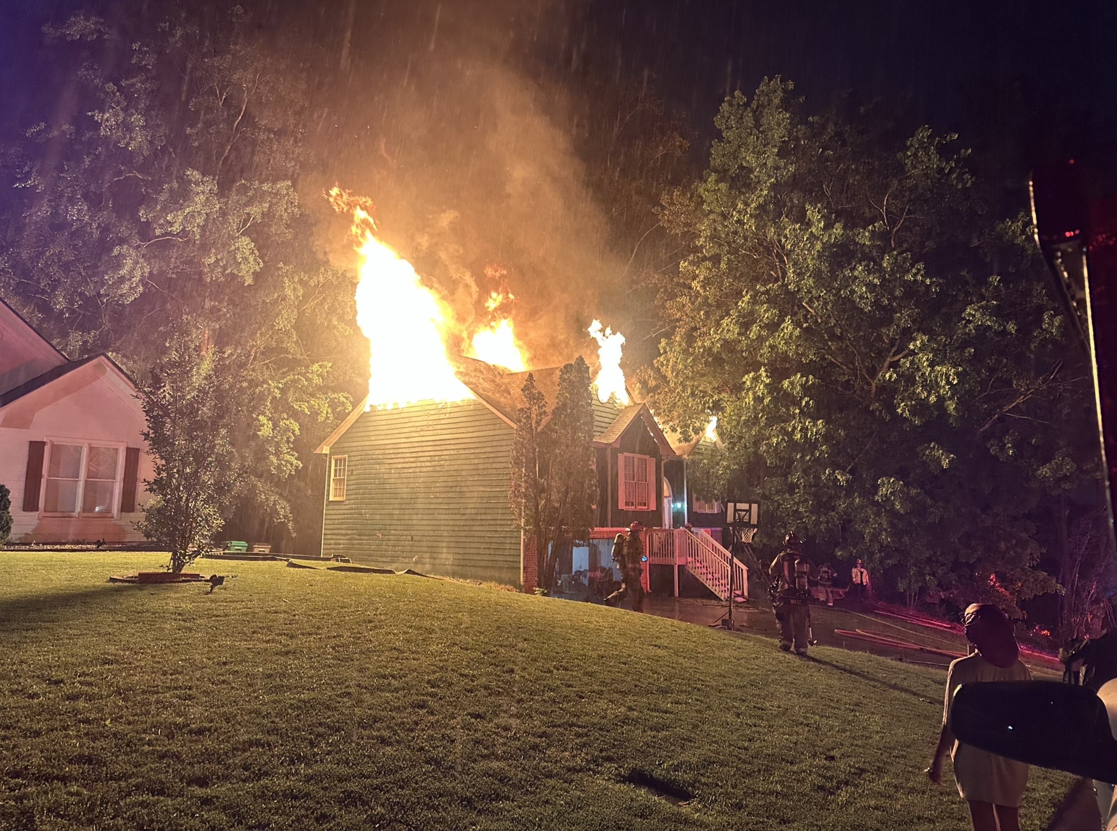 Gwinnett County fire crews battle a blaze at a home on Grouse Court after lightning struck it amid severe storms overnight Wednesday.