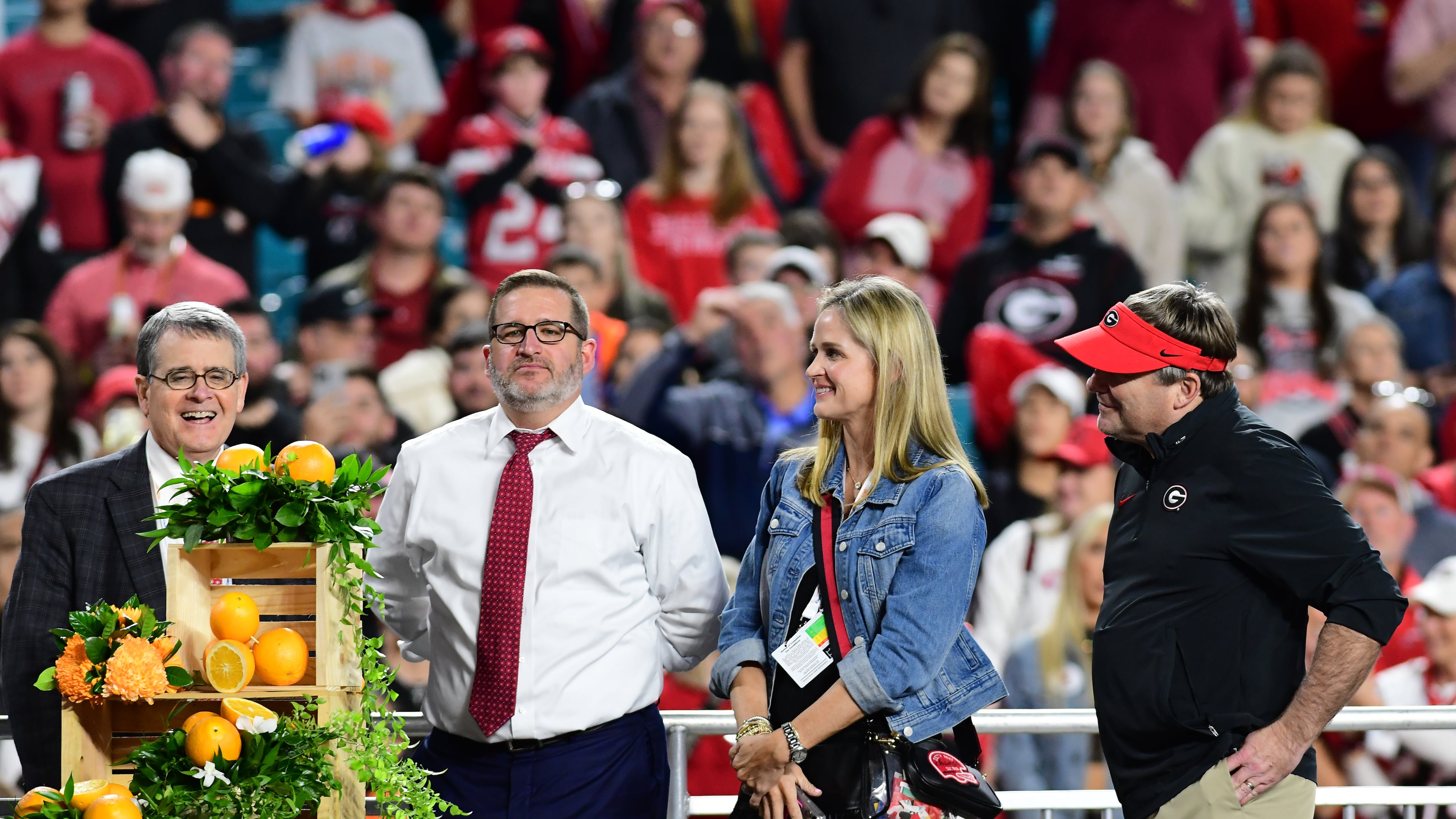 (From left): Jere Morehead, Josh Brooks, Mary Beth Smart and Kirby Smart take part in the trophy presentation following the 90th Orange Bowl game between Georgia and Florida State at Hard Rock Stadium inn Miami Gardens, Florida. (Perry McIntyre/UGA Sports Communications 2023)