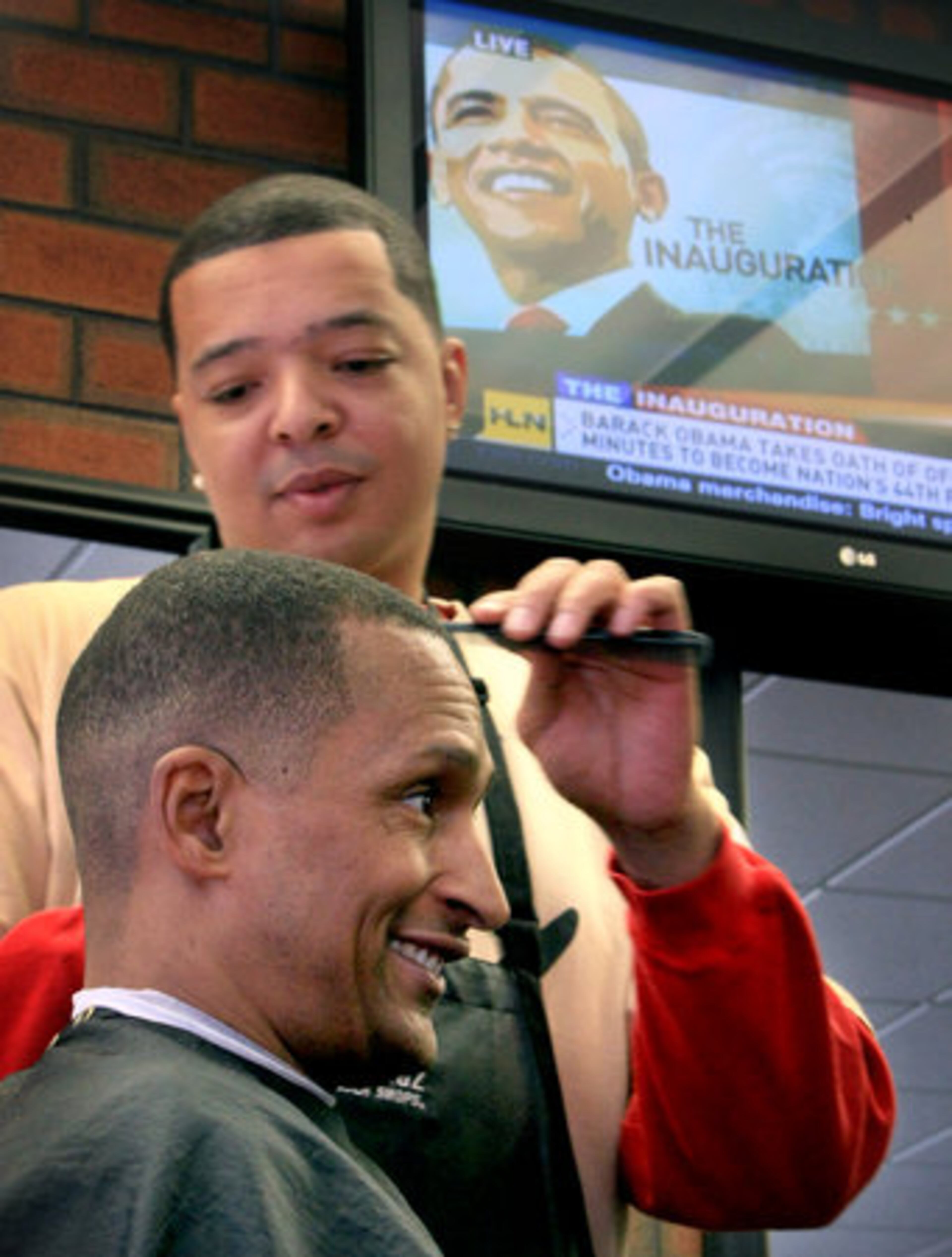 Barber Scott Echols cuts the hair of customer Dave Ramsey at Good Phellaz Barber Shop on Peachtree Street. Ramsey said he remembers Walters Shoe store in Atlanta being the only store where black people could use the front door.