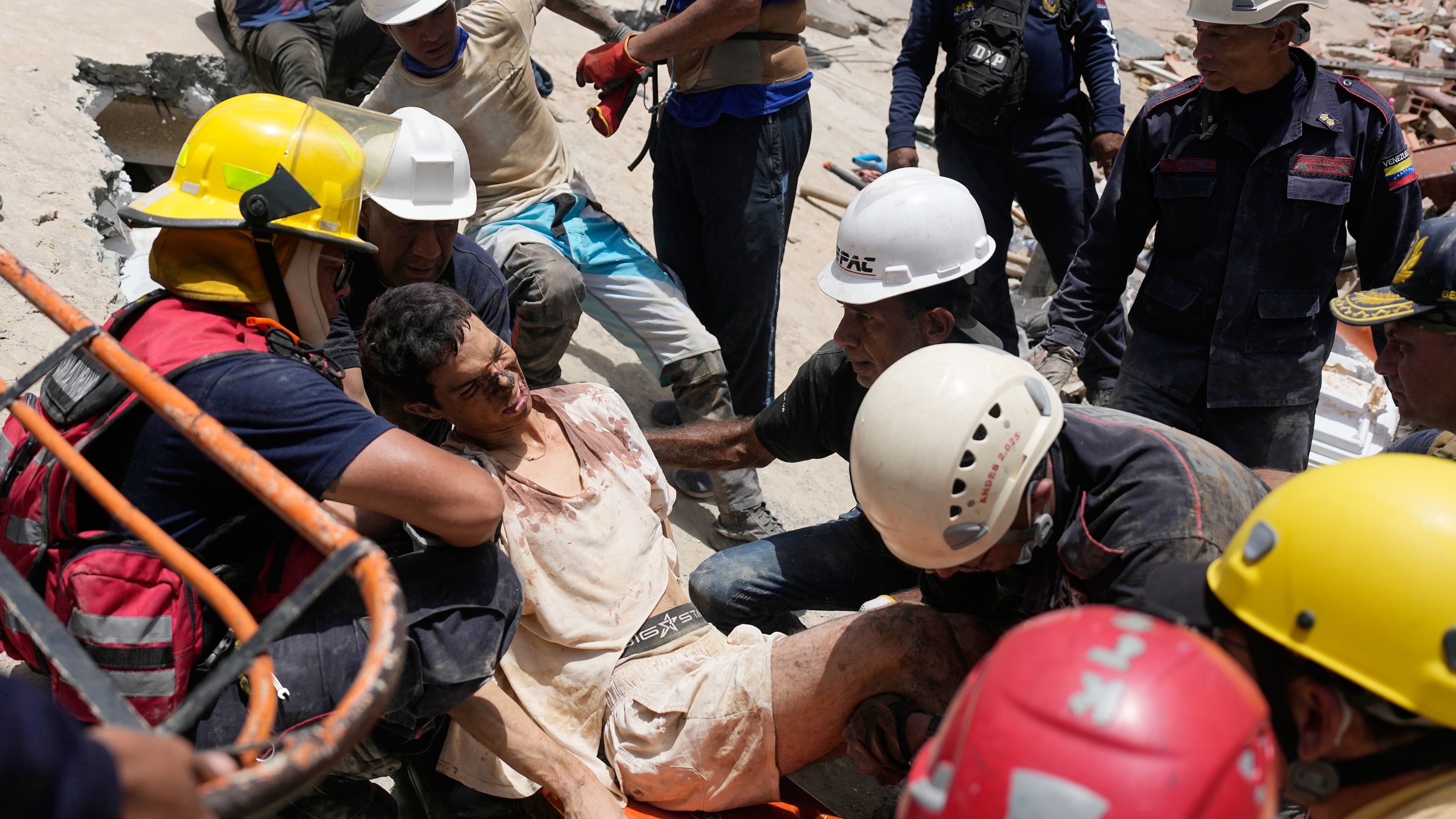 Rescue workers place Daniel Cordero on a stretcher after pulling him from the rubble two days after an earthquake struck Catia la Mar, Venezuela, Friday, June 26, 2026. (AP Photo/Fernando Vergara)