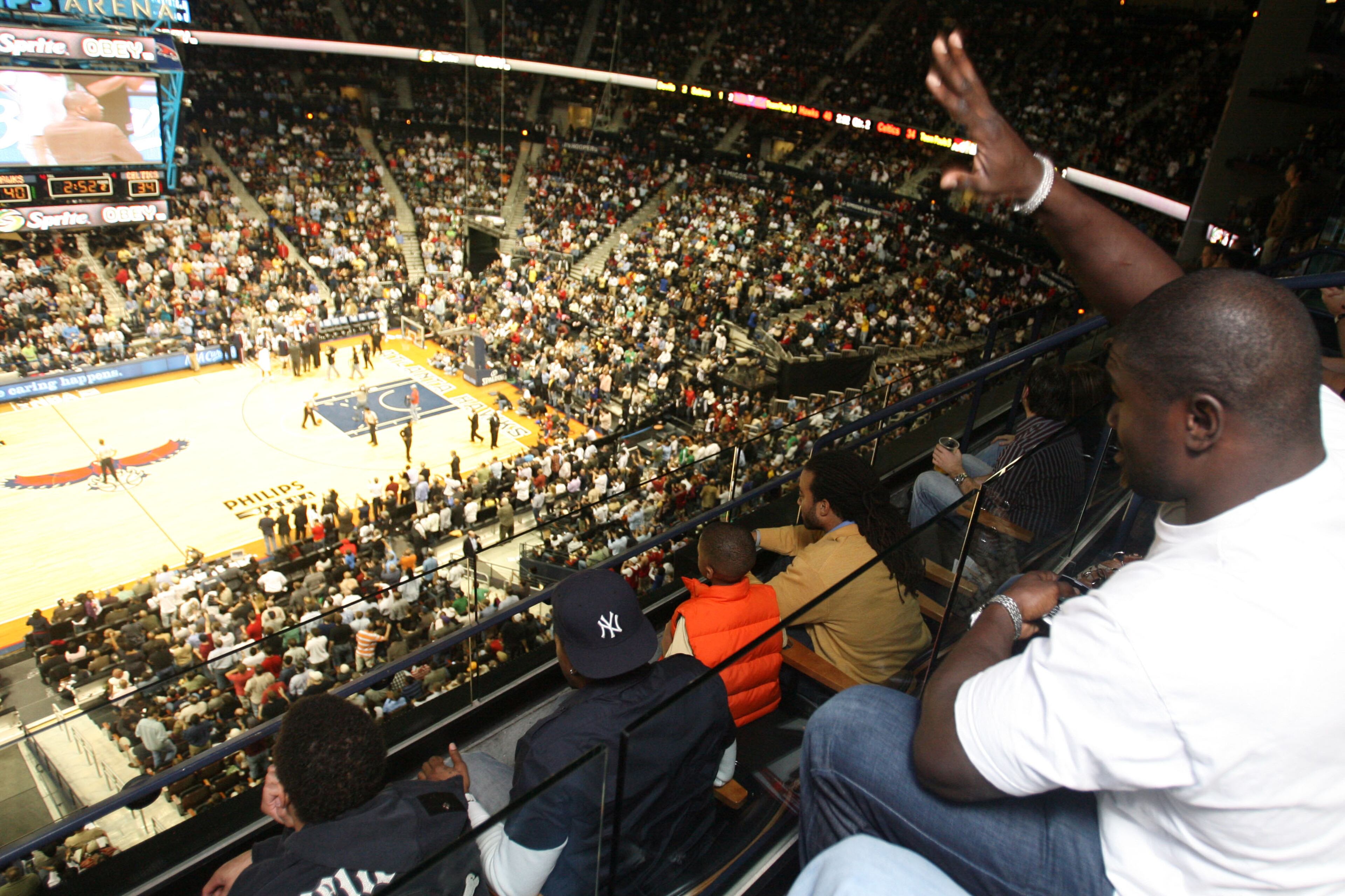 Ovie Mughelli takes in a Hawks game at Philips Arena in 2008. MIKKI K. HARRIS / mkharris@ajc.com