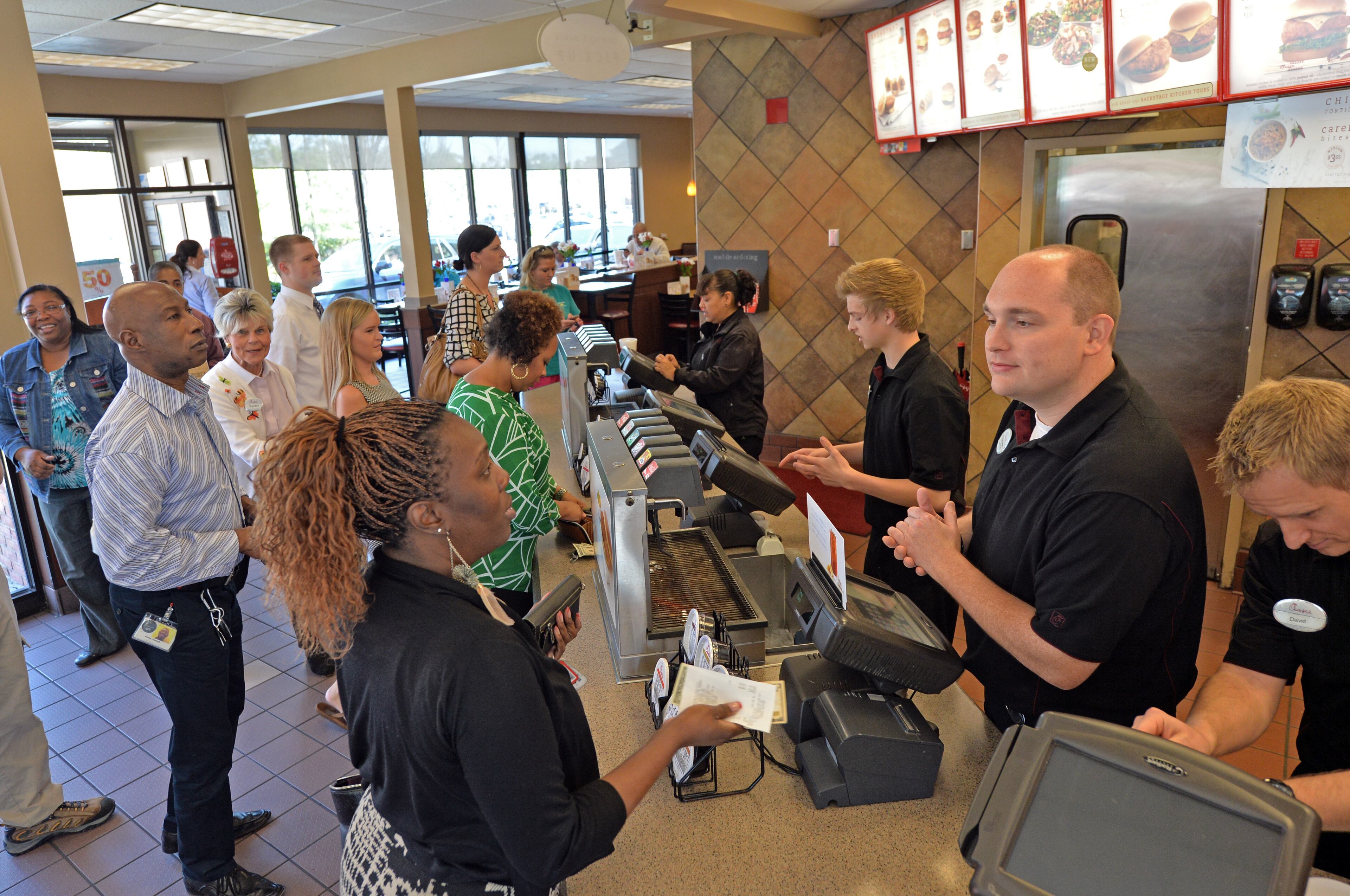 Dorian Hassler helps a customer Sona Darden at the Chick-fil-A Dunwoody location on Tuesday, April 1, 2014. Chick-fil-A has surpassed KFC as America's number one purveyor of fried chicken with sales greater $5 billion with a fraction of the stores fronted by the Colonel. HYOSUB SHIN / HSHIN@AJC.COM