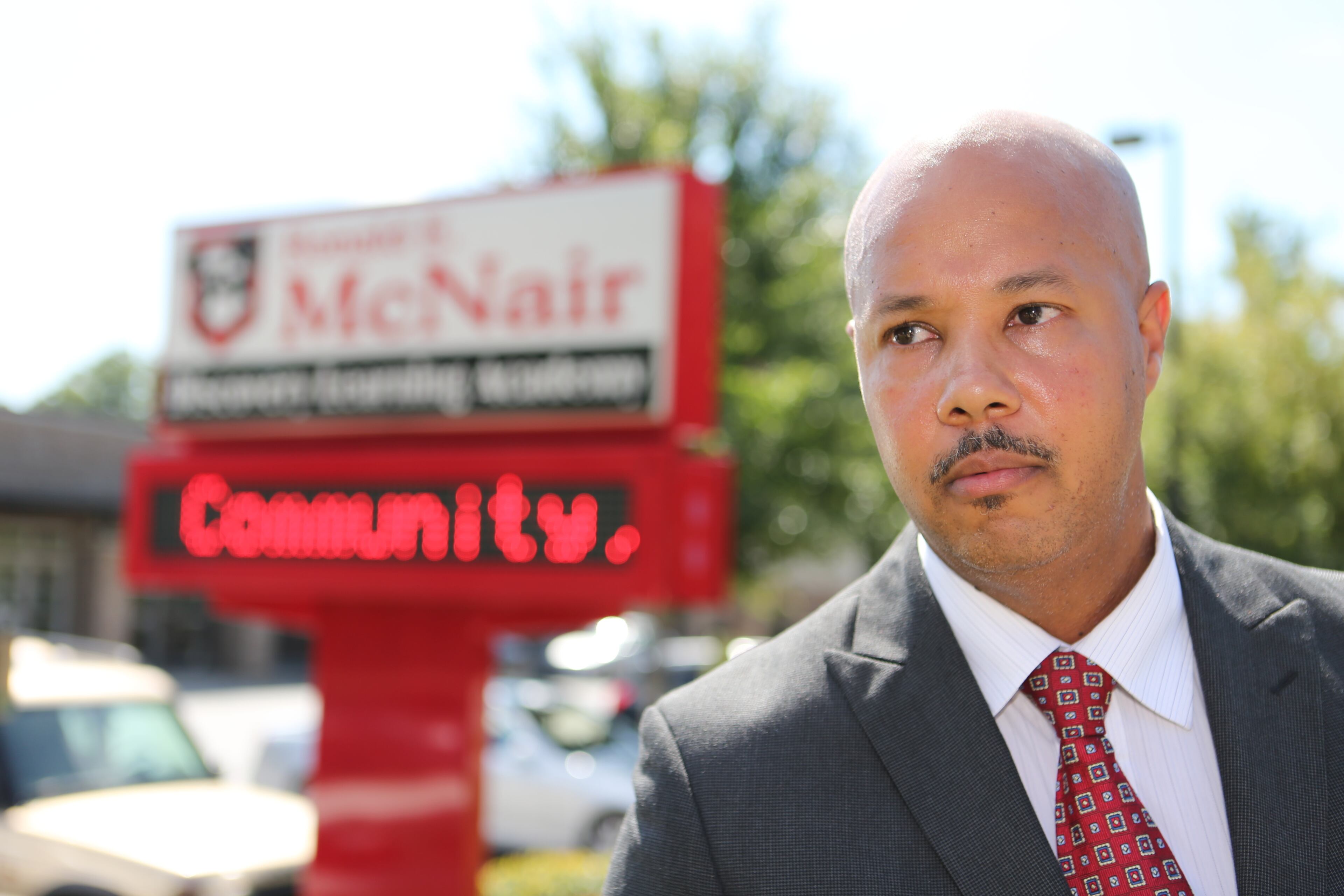 McNair principal Brian Bolden and DeKalb schools counselor Vasanne Tinsley hold a press conference as students return to campus.
