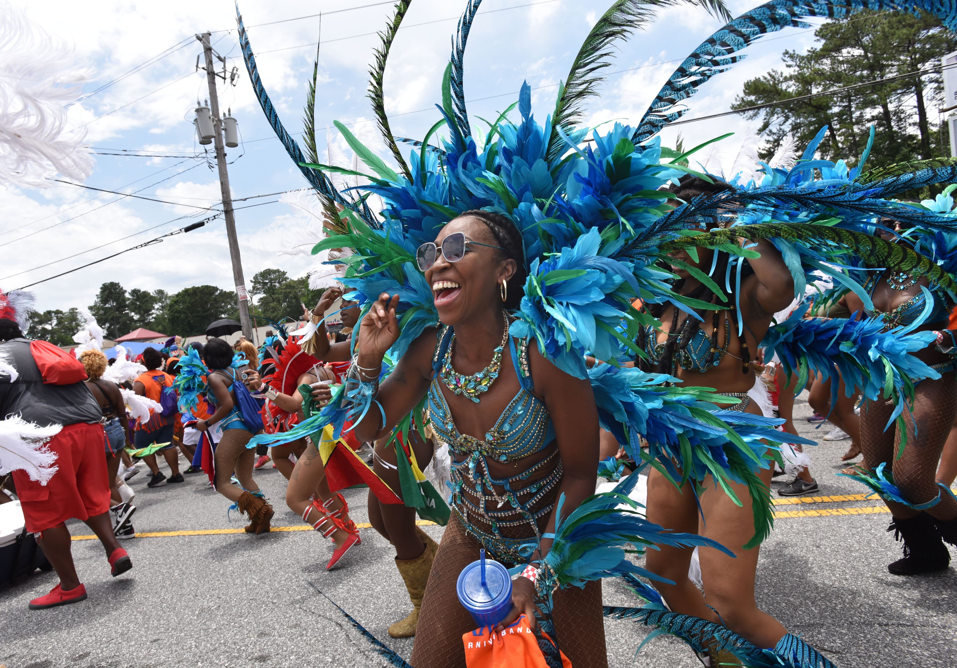 May 27, 2017 Decatur - Parade participants march down Covington Highway during Atlanta Caribbean Carnival Parade in Decatur on Saturday, May 27, 2017. The parade is hosted by Atlanta Carnival Bandleaders Council (ACBC) to promote a broader understanding and a deeper appreciation of Caribbean culture among the Atlanta community by seeking the interest of carnival bands and steel bands, and using the Atlanta Caribbean Carnival as a vehicle for the promotion of Caribbean culture. HYOSUB SHIN / HSHIN@AJC.COM
