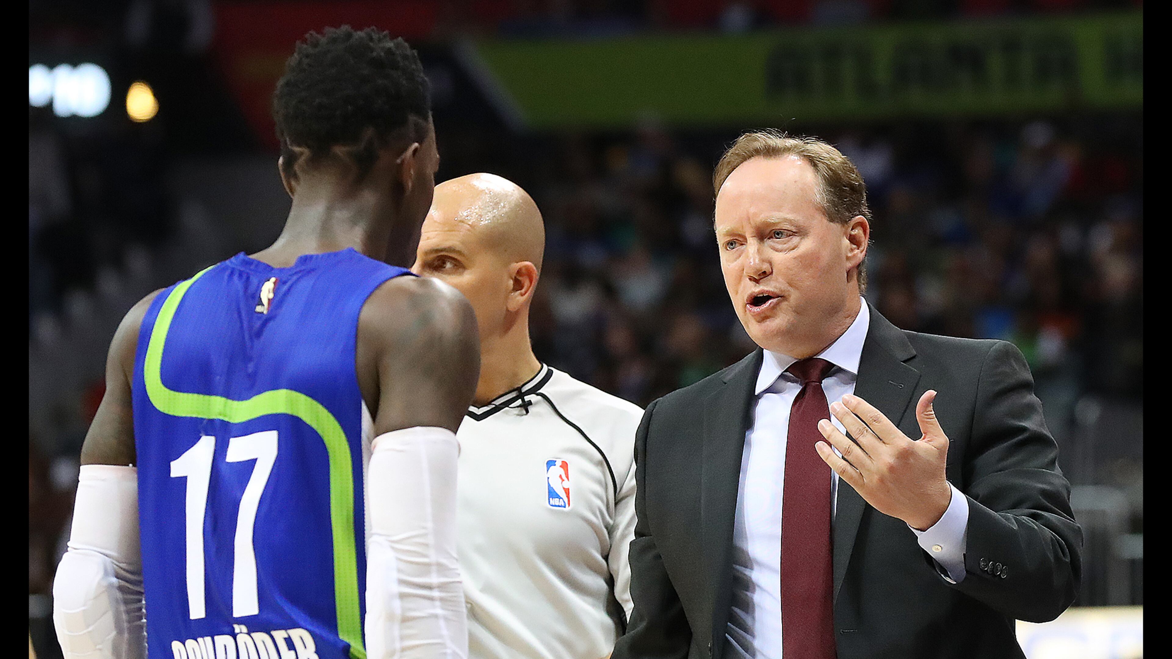 Hawks head coach Mike Budenholzer speaks with guard Dennis Schroder before benching him in the third quarter for the remainder of the game against the Golden State Warriors on Monday night. (Curtis Compton/ccompton@ajc.com)
