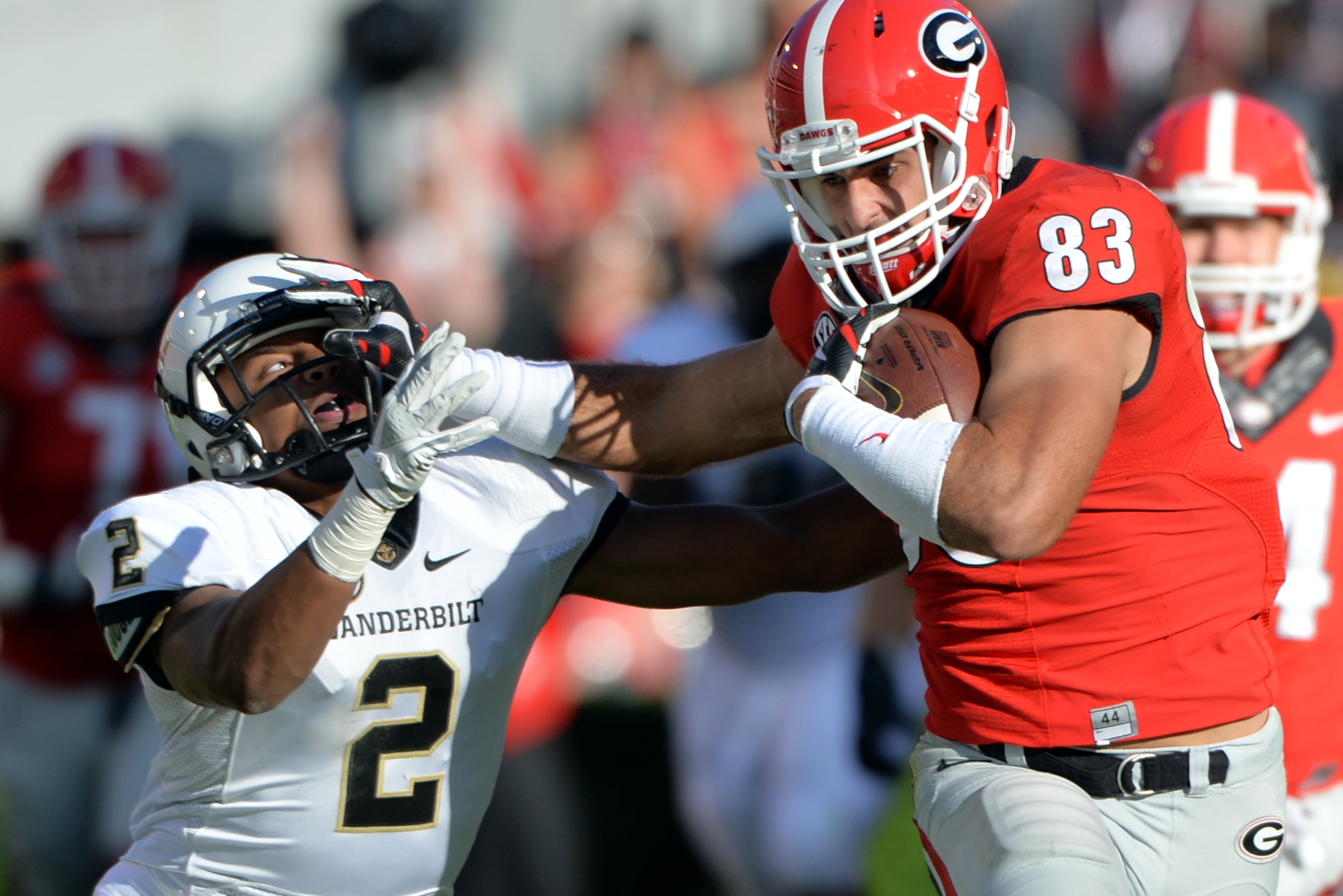 Tight end Jeb Blazevich: He turned in an impressive freshman season, including this stiff-arm of Vanderbilt defensive back Tre Tarpley after catching a pass from Todd Gurley on Oct. 4, 2014. BRANT SANDERLIN / BSANDERLIN@AJC.COM