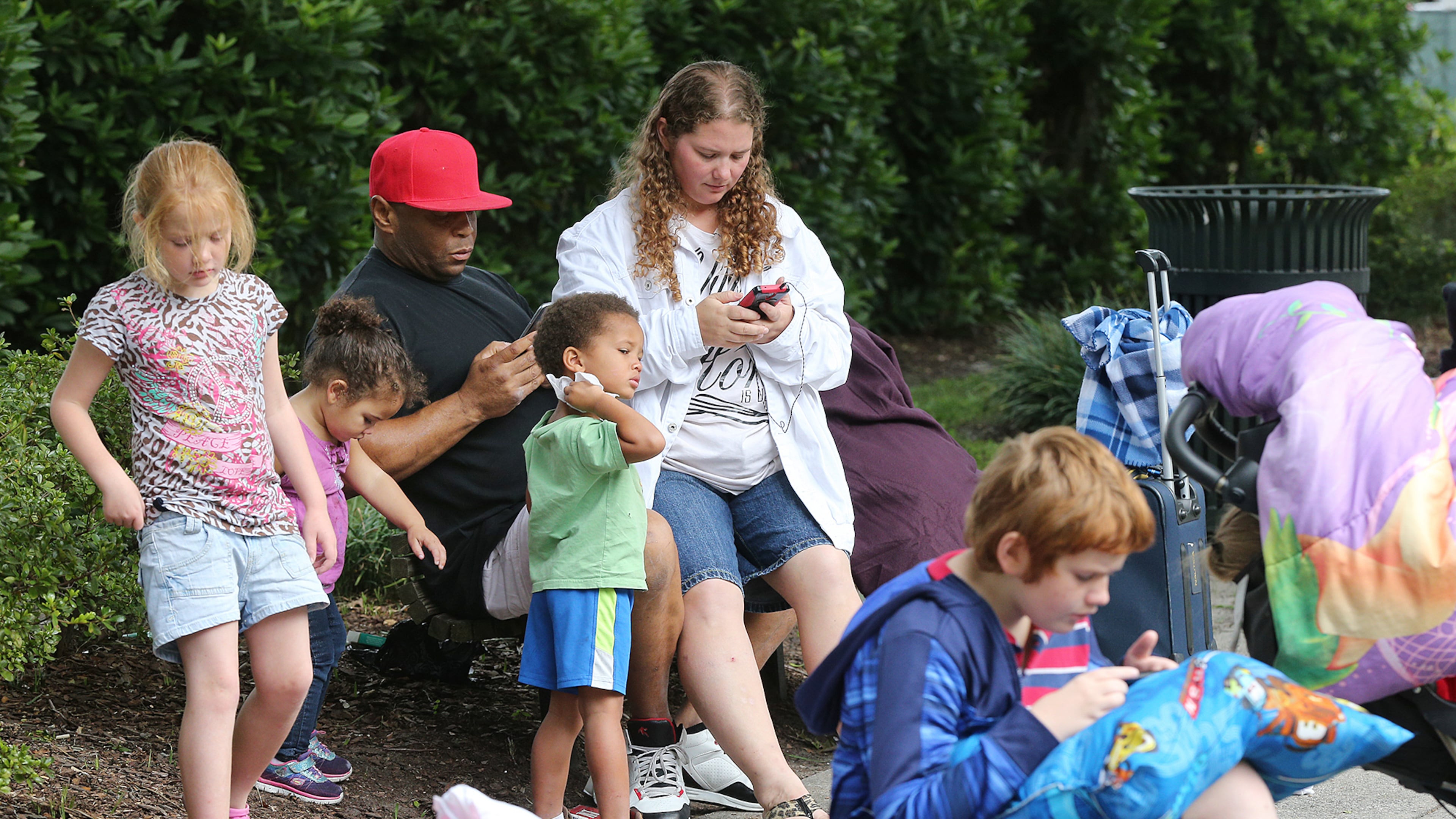 William Lavelle Daniels, his wife April, and their children join hundreds of other local residents being evacuated from the city at the Savannah Civic Center Saturday. Curtis Compton/ccompton@ajc.com