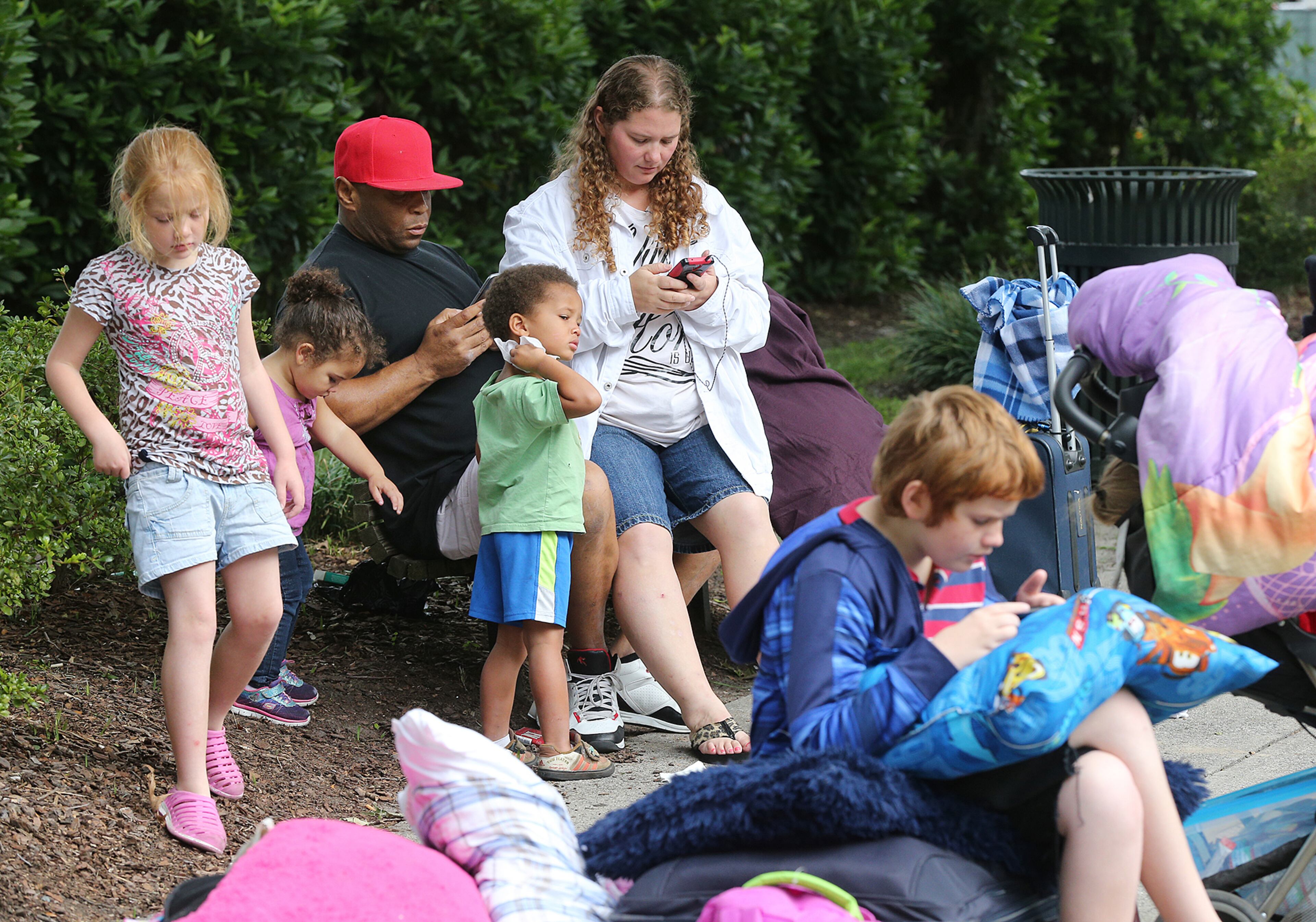 William Lavelle Daniels, his wife April, and their children join hundreds of other local residents being evacuated from the city at the Savannah Civic Center Saturday. Curtis Compton/ccompton@ajc.com