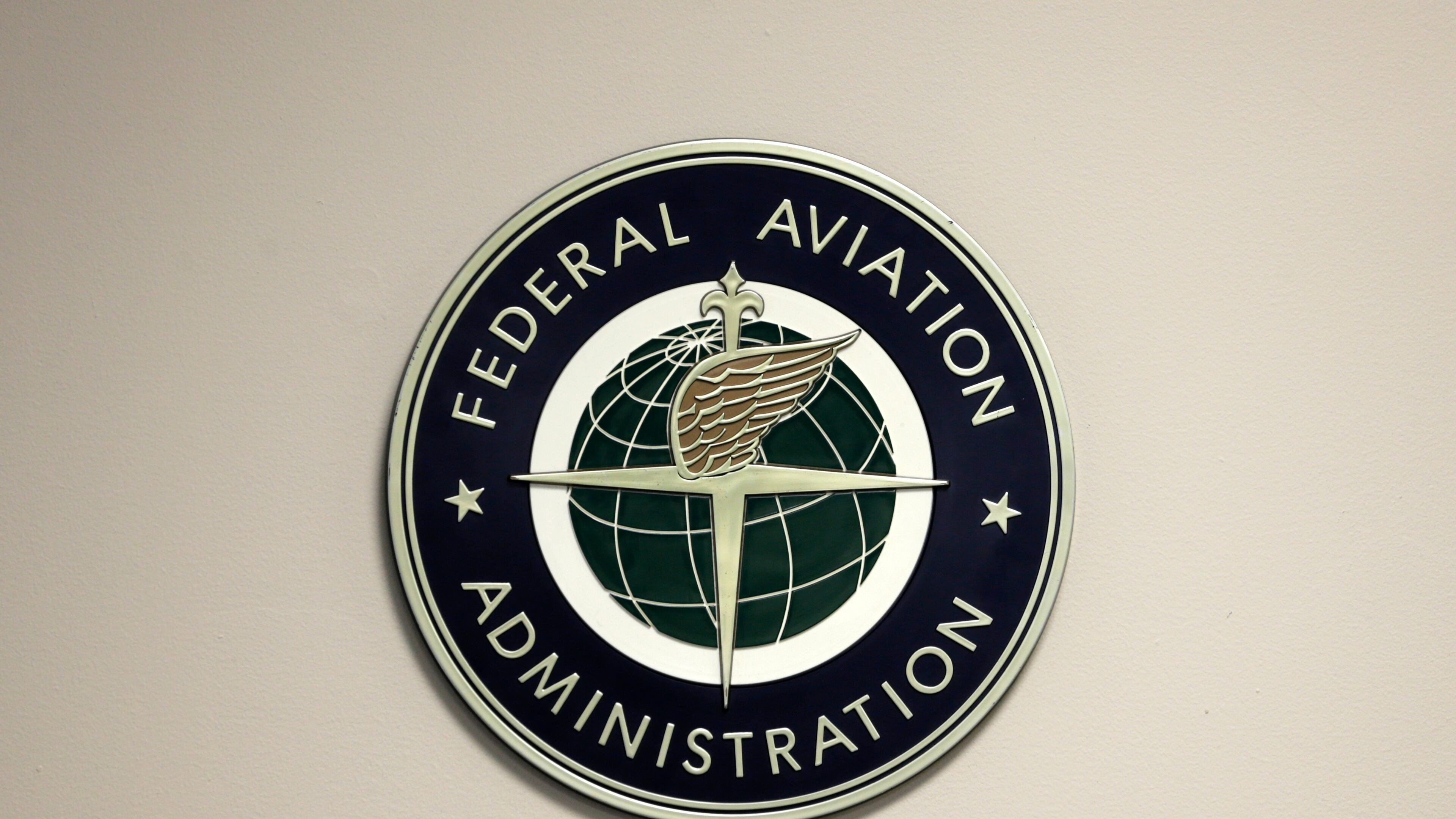 FILE - A Federal Aviation Administration sign hangs in the tower at John F. Kennedy International Airport in New York, March 16, 2017. (AP Photo/Seth Wenig, File)