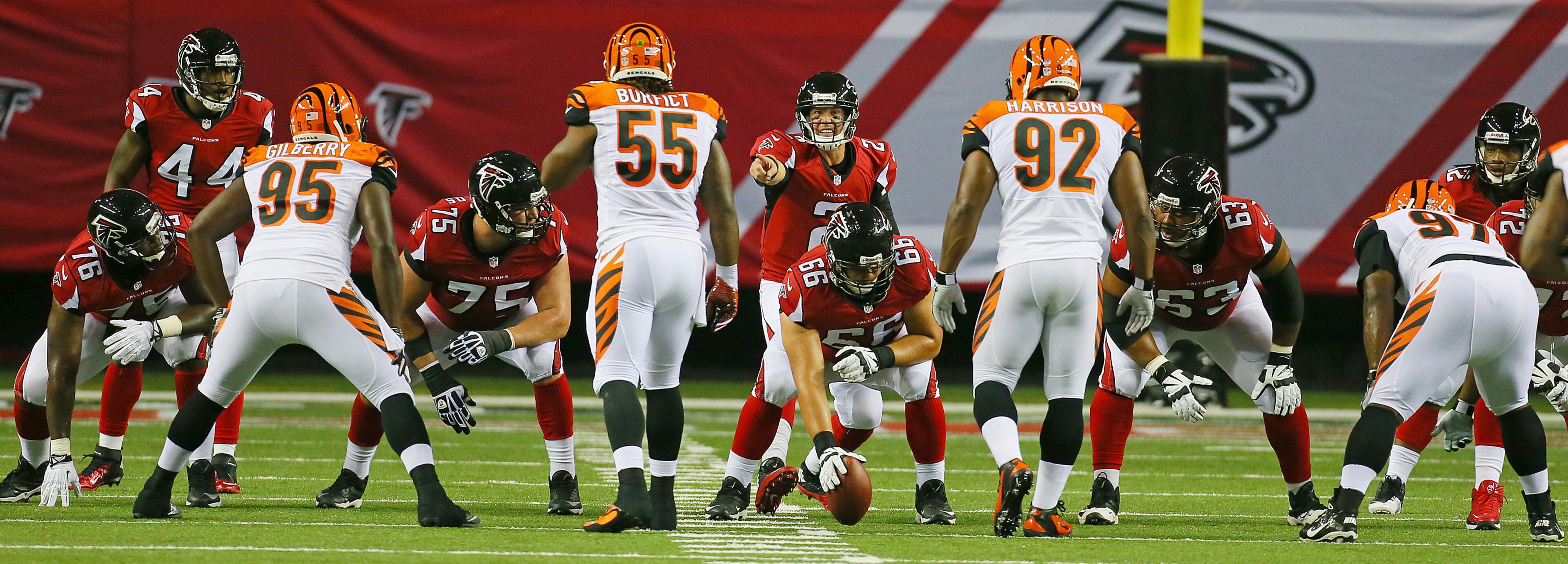 The Falcons offensive line faces off against the Bengals defense with Matt Ryan pointing out the coverage during the 1st quarter of their NFL exhibition game on Thursday, August 8, 2013, in Atlanta.