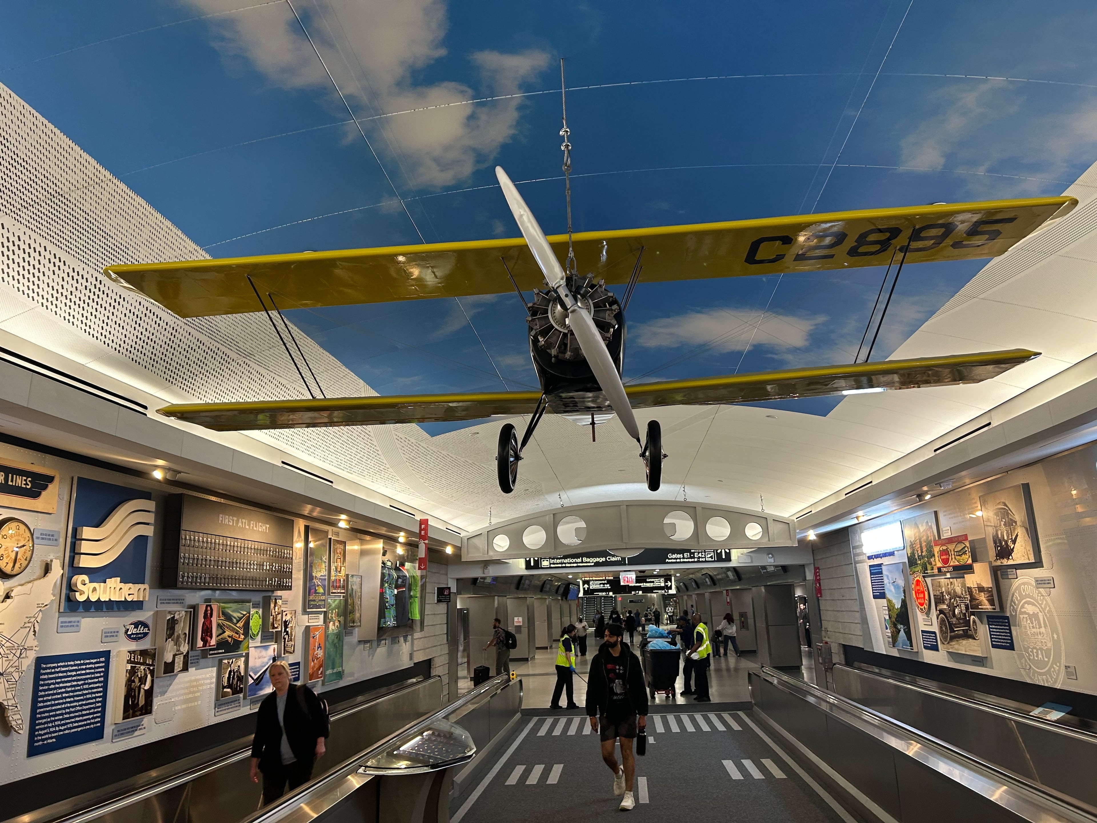 An exhibit in the tunnel between Concourses D and E celebrates a century of aviation. (Thomas Lake/AJC)