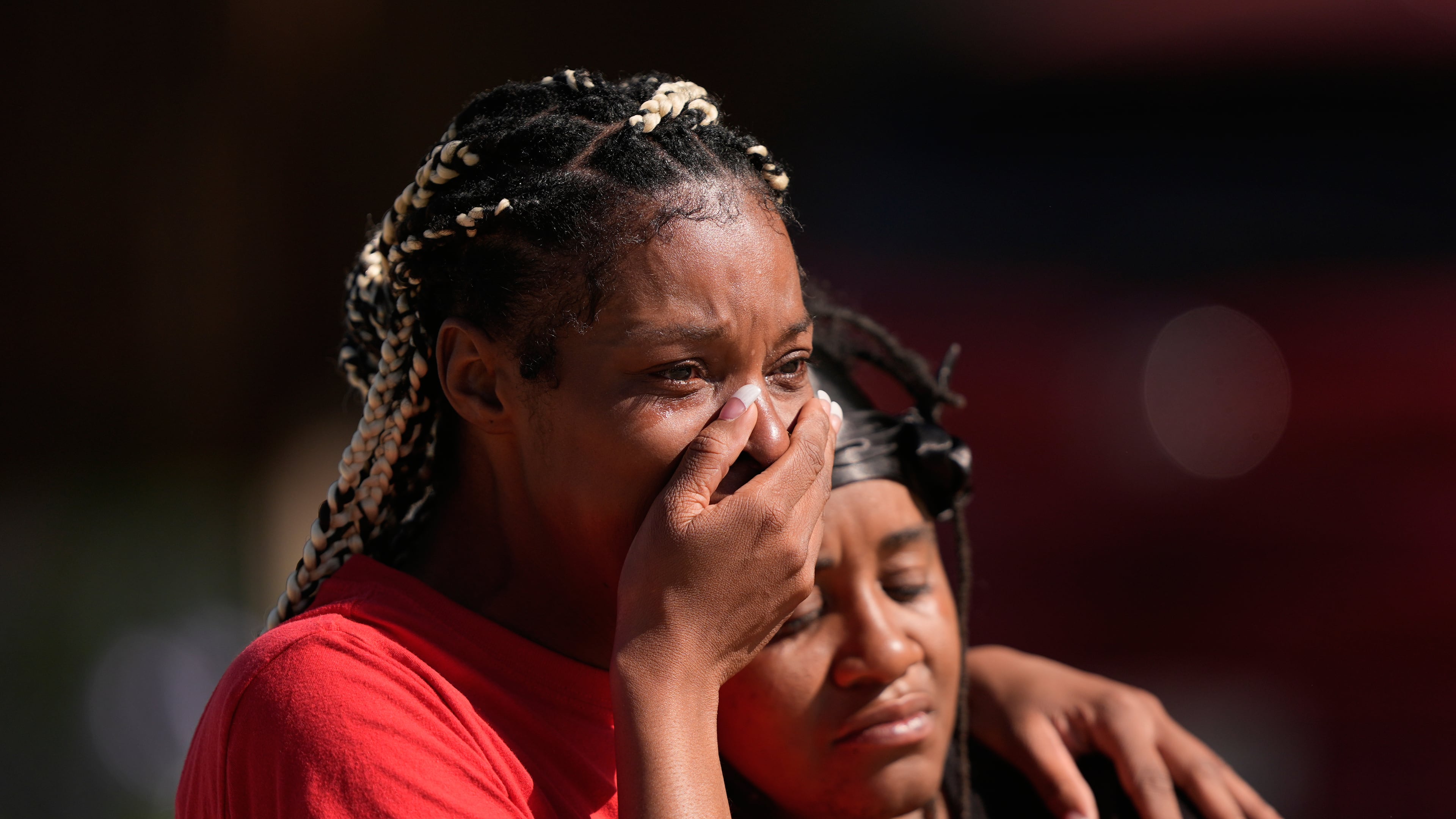 People grieve as they comfort each other outside the scene of a mass shooting, Sunday, April 19, 2026, in Shreveport, La. (AP Photo/Gerald Herbert)