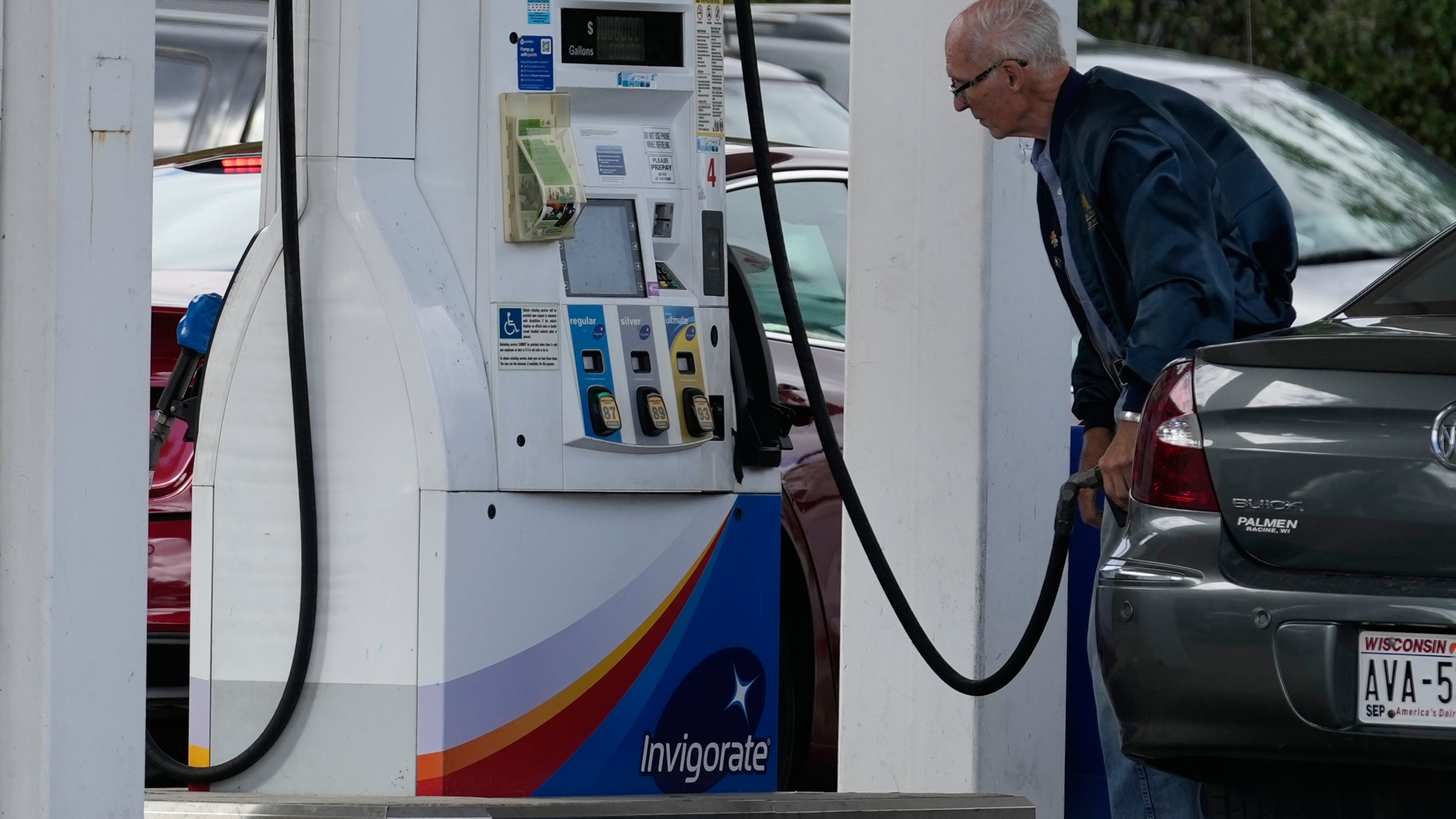 A customer checks gas price while he fills up his vehicle's tank at a gas station in Racine, Wis., Tuesday, Sept. 22, 2026. (AP Photo/Nam Y. Huh)